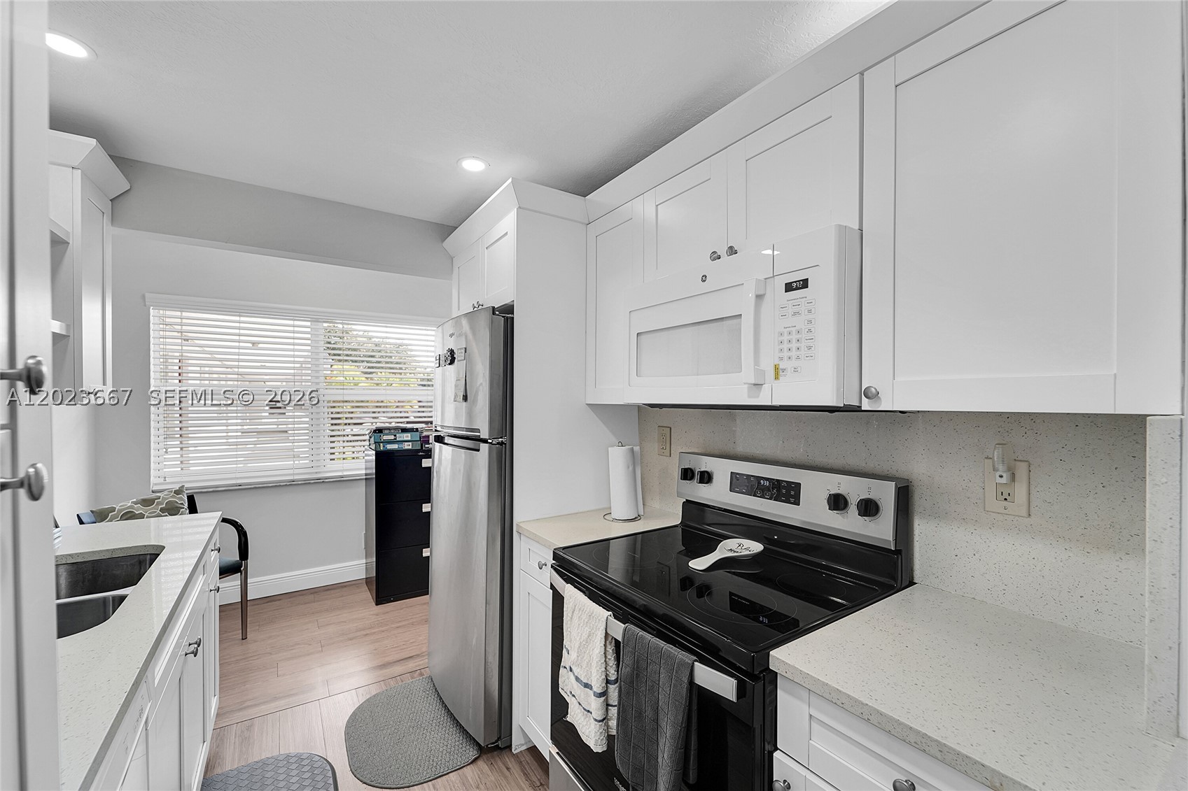 Bright and beautifully updated 1 bedroom, 1.5 bath condo in the peaceful and highly desirable 55+ community, Fairways of Tamarac. One of the nicest and most tastefully modernized units in the community, this second floor residence is ideally located next to the elevator for added convenience. Features include stainless steel appliances, modern kitchen cabinetry, luxury vinyl tile flooring, hurricane-impact windows, a tankless electric water heater, travertine accent wall, custom walk-in closet shelving, and a full size in-unit washer/dryer. Enjoy tranquil golf course views and bird watching from the screened balcony. The community offers resort-style amenities including a clubhouse, pool, jogging path, cable, fiber-optic internet, ample guest parking, and beautifully maintained grounds. The building has already passed its 40-year certification and the roof was recently replaced in 2025. HOA requires a minimum 700 credit score. This home is pristine and move-in ready. Come make it your own!