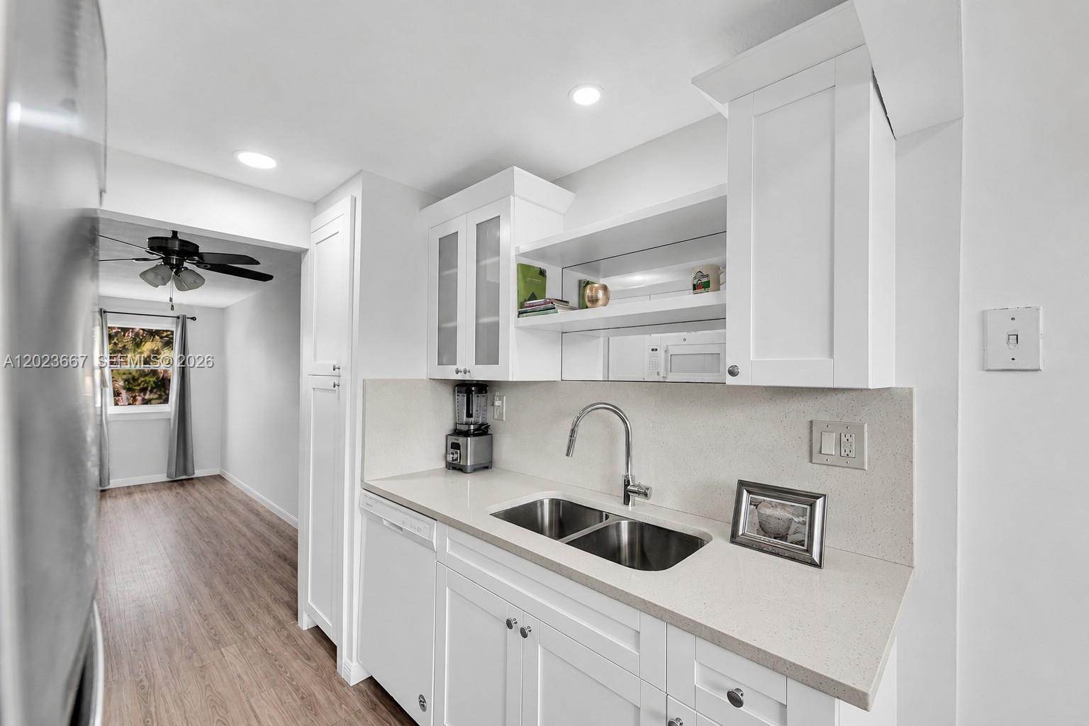 Bright and beautifully updated 1 bedroom, 1.5 bath condo in the peaceful and highly desirable 55+ community, Fairways of Tamarac. One of the nicest and most tastefully modernized units in the community, this second floor residence is ideally located next to the elevator for added convenience. Features include stainless steel appliances, modern kitchen cabinetry, luxury vinyl tile flooring, hurricane-impact windows, a tankless electric water heater, travertine accent wall, custom walk-in closet shelving, and a full size in-unit washer/dryer. Enjoy tranquil golf course views and bird watching from the screened balcony. The community offers resort style amenities including a clubhouse, pool, jogging path, cable, fiber-optic internet, ample guest parking and beautifully maintained grounds. The building has already passed its 40-year certification and the roof was recently replaced in 2025. HOA requires minimum 700 credit score. This home is pristine and move-in ready. Come make it your own!