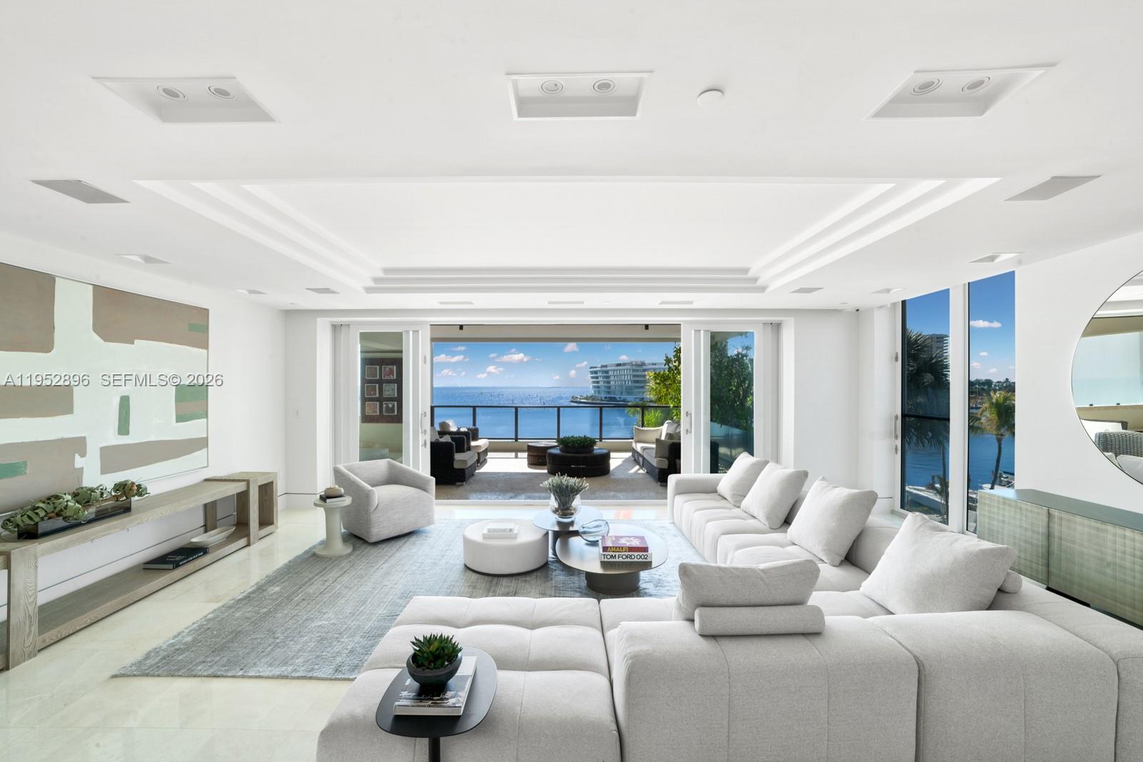 Expansive flow-through waterfront unit at the Residences at Vizcaya offering the scale and layout of a private home with the convenience of full-service amenities. Flooded with natural light and framed by sweeping Biscayne Bay views, this oversized residence welcomes you through a grand foyer into expansive open living and entertaining spaces that flow effortlessly to a large private terrace overlooking the pool and bay. The gourmet chef’s kitchen features marble countertops, custom cabinetry, an oversized island with breakfast bar seating, and top-of-the-line Miele appliances. Two expansive primary suites offer terrace access and oversized custom walk-in closets, including a main suite positioned to capture direct bay views. Two additional bedrooms complete the residence, including one with terrace access and en-suite bath, and another currently configured as an office/entertaining space. Additional highlights include private elevator entry, a staff suite with full bath and Thermador wine coolers + convenient access to the laundry room, integrated Sonos audio system, Lutron lighting, 3 assigned parking spaces, and a storage unit. Residents enjoy resort-style amenities including a private marina, lap pool with cabanas, jacuzzi, two spas, state-of-the-art fitness center, social club room, and an approximately 5,000 SF private botanical garden.