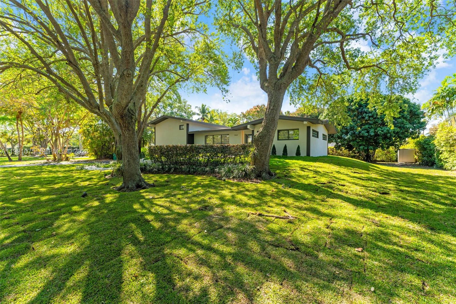 Nestled under a canopy of trees and lush greenery, this 3BD/2BA split-level home in the heart of Pinecrest is move in ready, with new impact windows, new roof, and updated flooring, bathrooms and kitchen. The open floor plan and large windows create a bright and peaceful energy throughout. The backyard is a retreat-like oasis. Its patio space ideal for hosting, a large garden for yoga or soccer, and a vibrant pool for hot summer days! The primary bedroom is its own private wing on the second floor, with its own private balcony. The home enjoys generous storage space, a walk-in kitchen pantry, new appliances, fruit trees, and a 2-car garage. It's located in the highly sought-after Palmetto School District and just minutes away from some of the best parks, shopping, and dining in South Florida, emblematic of the classic Pinecrest lifestyle!