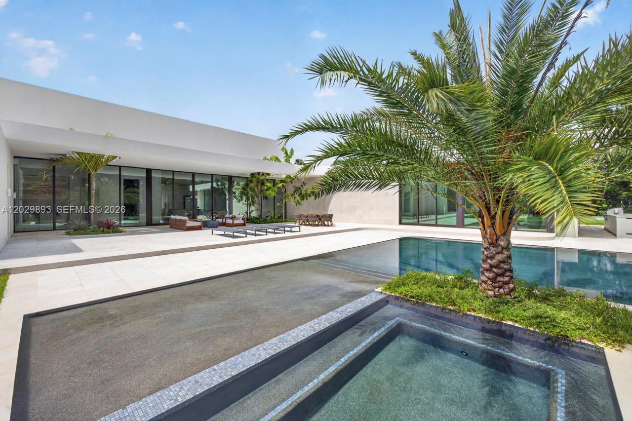 A newly completed architectural masterpiece in the prestigious enclave of Southwest Ranches, this 9,578 SF  estate offers an expansive 12,618 square feet of covered living space that masterfully blurs the boundaries between grand interiors and resort-style outdoor living on 2.5 acres. With six expansive bedrooms and eight impeccably appointed bathrooms — including a private master wing designed as a true personal sanctuary — every detail reflects uncompromising scale, sophistication, and craftsmanship. Entertain seamlessly in the cabana/gym, study, theater, formal living room, and family room, supported by a gourmet kitchen and a discreet butler’s kitchen. The distinctive architecture opens to serene courtyards and lush gardens, where mature trees rise dramatically through sculptural roof cutouts. Outside, indulge in the resort-caliber pool and spa, summer kitchen, and private sports court.