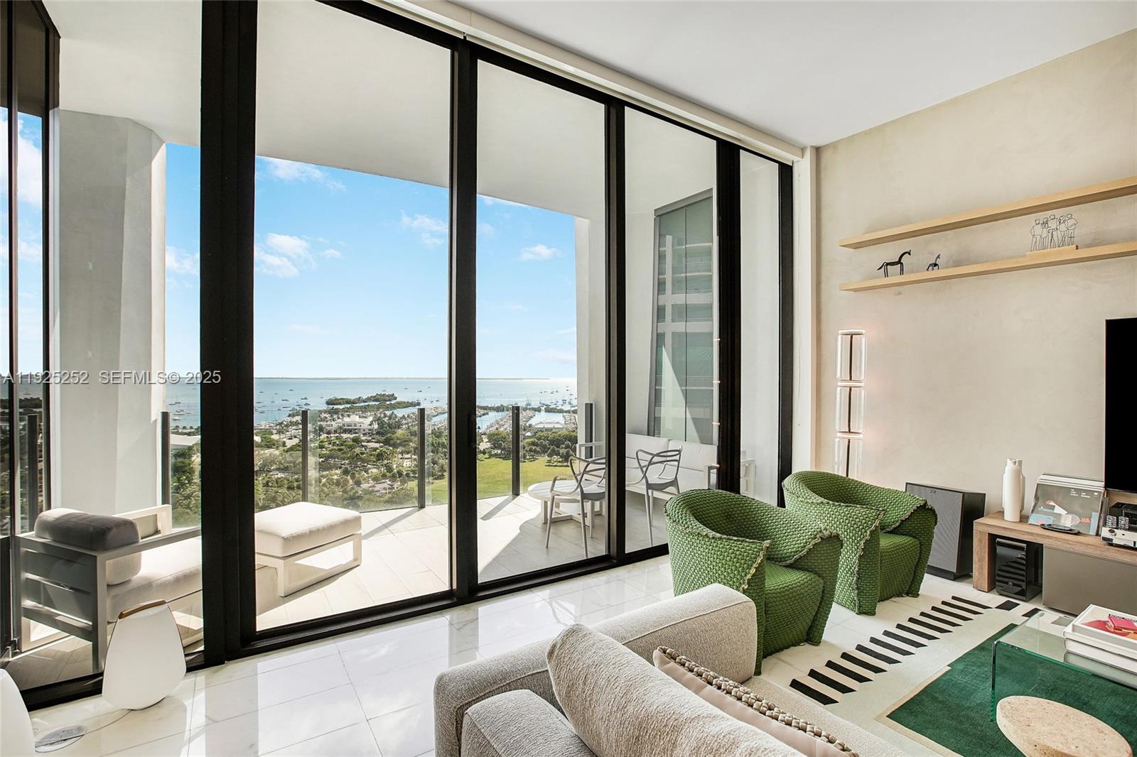Experience the ultimate in luxury living in Coconut Grove with this exquisite 15th-floor residence at Two Park Grove. This rarely available C-line unit offers unparalleled views of Biscayne Bay, perfectly framed by soaring 12-foot floor-to-ceiling windows. The residence features three bedrooms, enhanced with upgraded finishes, custom wood paneling, cabinetry, and a private elevator entry, ensuring the highest level of exclusivity.

Step out onto the oversized terrace accessible from both the primary bedroom and the living room to enjoy stunning sea views. Two Park Grove is synonymous with luxury, offering amenities akin to the world's most exclusive private clubs. Residents enjoy the services of a concierge, 24-hour valet, a state-of-the-art fitness center, a signature spa, a children's playroom, a movie theater, a wine cellar, and a private dining room and more.

This location offers the perfect blend of convenience and sophistication, just minutes away from exceptional shopping, dining, and top-rated schools, with easy access to the vibrant Brickell district. Discover a lifestyle in Coconut Grove like no other, offered exclusively by this exceptional building.