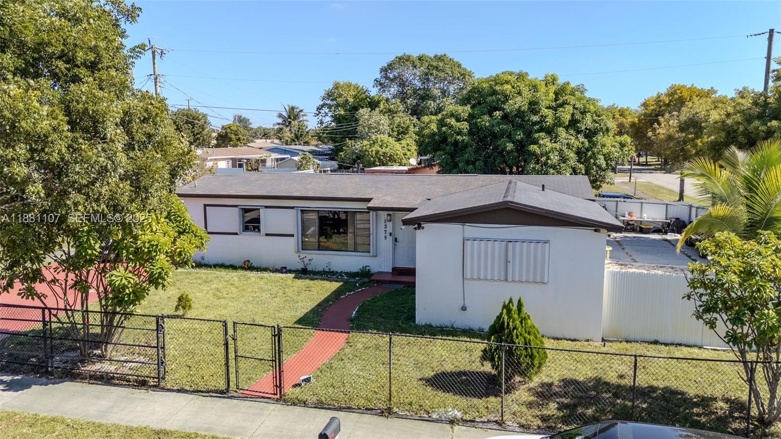 This Single Family Home offers the perfect combination of location, comfort, and potential. Just minutes from the Hard Rock Stadium, with quick access to the Turnpike and Palmetto, and conveniently located near Aventura Mall. It also has nearby access to public transportation, making it a practical and convenient option. The home features 3 bedrooms, a versatile DEN (perfect as an office, playroom, or extra room), 2 full bathrooms, and 1,368 sq ft of living space. Its spacious backyard is ideal for decorating, personalizing, and enjoying family gatherings, BBQs, or simply relaxing. Located in a quiet neighborhood, offers quality of life in a cozy space with great ROI potential due to its strategic location. Don’t miss the opportunity to live or invest in the heart of Miami-Dade!