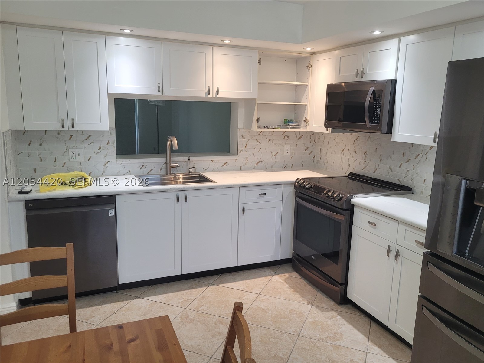 Own a Piece of Paradise in the highly sought-after gated community of Century Village! This beautifully maintained 2-bedroom, 2-bathroom condo features a fully renovated kitchen with stainless steel appliances, in-unit washer and dryer, tile flooring throughout, a spacious walk-in closet, and a large screened balcony—perfect for relaxing and enjoying the Florida lifestyle. Conveniently located on the second floor of an elevator building, the unit also includes one assigned parking space with abundant guest parking. Enjoy resort-style living in this vibrant 55+ community offering a spectacular clubhouse, fitness center, swimming pools, tennis courts, golf course, transportation services, 24-hour gated security, and countless social activities. Don't miss your chance to own this exceptional property—it won't last long!