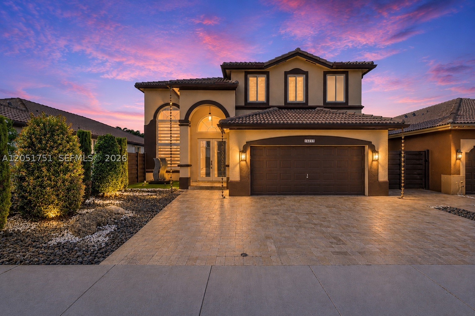Some homes offer a view. This one commands it. Perfectly positioned on one of the community's most coveted lakefront lots, this majestic 5-bedroom, 4-bath estate captures breathtaking panoramic water views from both the expansive balcony and covered terrace, creating an outdoor experience that's simply unmatched. A full bedroom and bath on the first floor provide the ideal space for guests or multigenerational living. The resort-inspired backyard with heated spa/pool is designed for unforgettable entertaining and peaceful evenings alike. Inside, timeless elegance meets modern luxury with soaring vaulted ceilings, crown molding, recessed lighting, a striking custom iron and wood staircase, and travertine flooring throughout the interior and exterior. The chef's kitchen features marble countertops, premium appliances, and a professional hood vent, while custom built-in closets maximize storage throughout. Impact windows and doors provide complete storm protection. Within the last five years, the HVAC, water heater, pool and spa heater, rain gutters, fences, and window treatments have all been replaced, and all appliances were updated in 2022. Parking for up to 6 vehicles, including a 2-car garage. Low HOA. Ideally located near Baptist Hospital West, exceptional dining, shopping, and major conveniences, this home delivers luxury, privacy, and a waterfront lifestyle that's difficult to replicate.