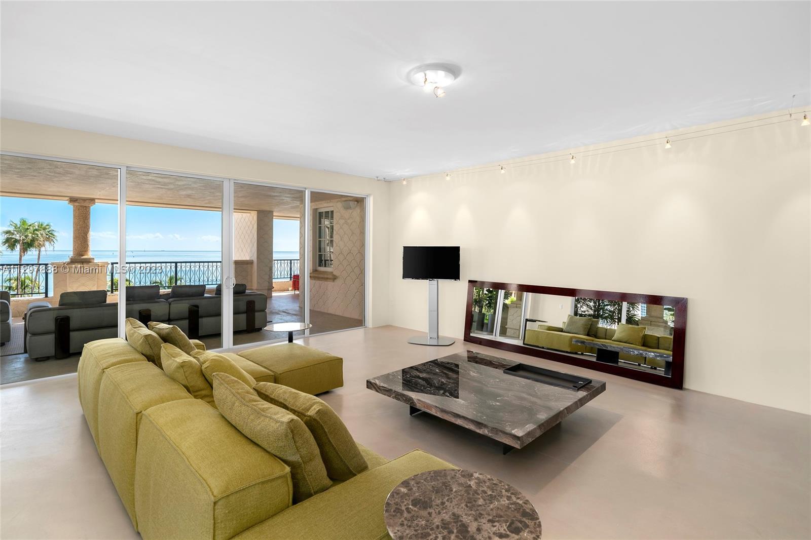 Watch the sunrise and enjoy the ocean breezes from this spacious Northeast oceanside corner unit.  Features 3BR/4+1BA and 3,959 SF with an open living and dining layout surrounded by walls of glass and direct access to an expansive wraparound terrace with comfortable seating areas that offer views to Miami Beach, Government Cut and the Atlantic Ocean. A large open kitchen sports granite countertops, a rolling center island, Gaggenau appliances and a separate breakfast area. The private principal suite features a seating area, direct access to the oceanside terrace, dual walk-in closets and dual bathrooms. The 2 other bedrooms are each spacious with en-suite bathrooms and share a terrace with views to Fisher Island. Enjoy 5-star Fisher Island amenities.