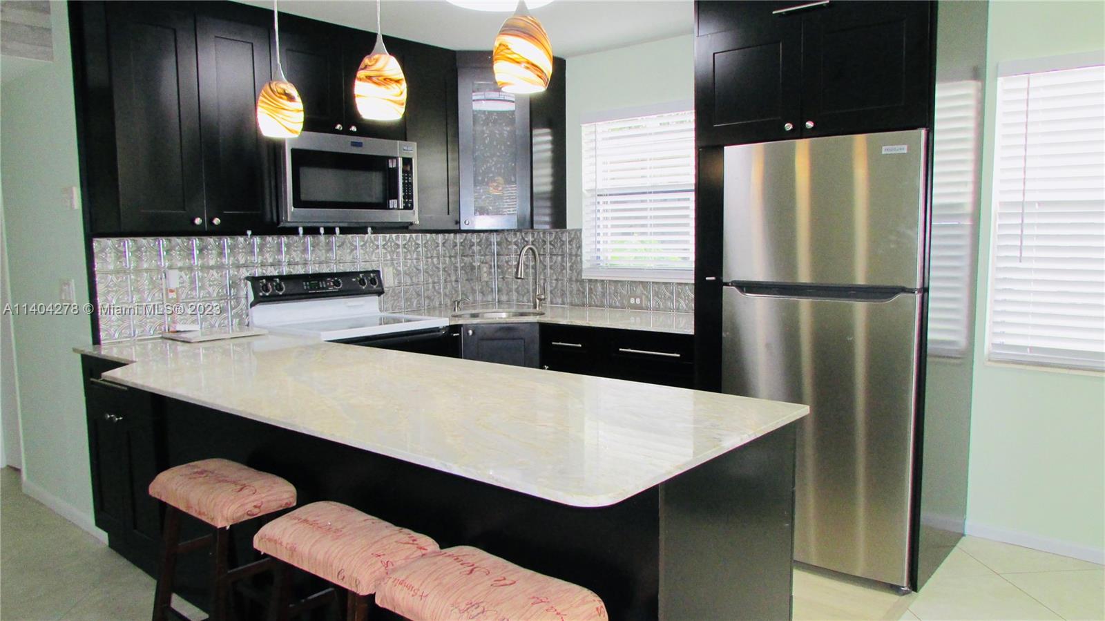 Freshly updated 1st floor Corner unit featuring tiles throughout. Updated kitchen featuring an island with newer Cabinets, granite counter tops and Stainless Steel Appliances. Bathrooms beautifully renovated with New Tiles and Vanity. Covered Porch overlooking Beautiful Green Garden. This Bright and Spacious Condo is ready for move In. Enjoy this Amazing Century Village 55+ Community with an Active Adult Lifestyle. The Clubhouse has 24 Hour Security, Gated Community, Great Fitness Center, Movie Theater, Shows, Library, Dancing, 16 Heated Pools, Tennis, Pickle-Ball, Shuffle Board, Billiard Tables, Transportation To Malls, Restaurants, Shopping, Doctors and Much More. 
700+ Credit score is a MUST!!
