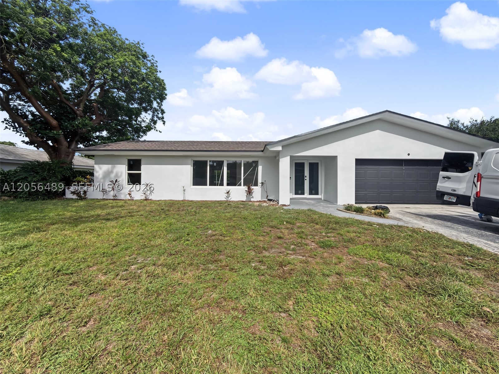 Stunning, fully renovated 4-bedroom, 2-bath pool home in the heart of Plantation! Rebuilt from the studs with designer finishes, this move-in-ready gem offers sun-filled open-concept living over sleek Calacatta-style porcelain tile, fresh paint, and modern recessed lighting throughout. The brand-new kitchen dazzles with white shaker cabinets, stainless steel appliances, granite counters, and a designer backsplash, plus a handy second wet-bar area off the family room. Both spa-inspired baths boast frameless glass walk-in showers, rain shower heads, floating vanities, and bold matte-black fixtures. Outside, a private screened-in pool and oversized covered lanai create the ultimate Florida oasis for year-round entertaining. Complete with a 2-car garage, spacious bedrooms with ample closets, and lush new landscaping. Minutes to I-595, the Turnpike, shopping & dining. Truly turnkey—nothing to do but move in and enjoy!