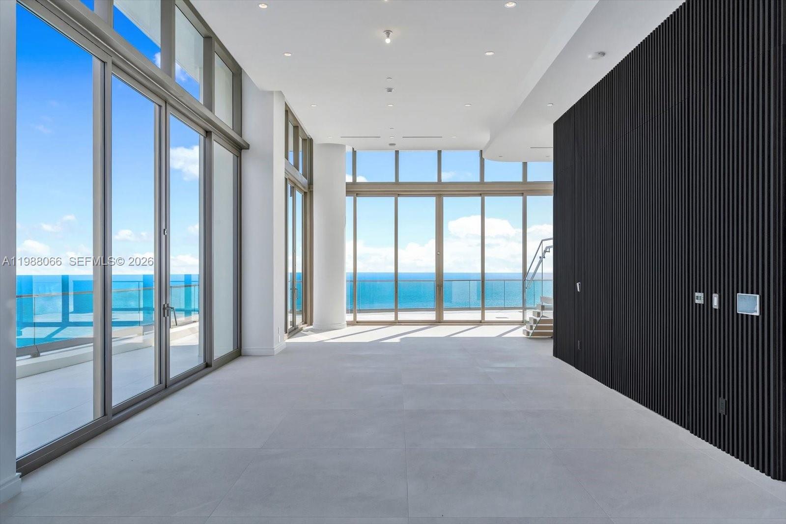 Experience the pinnacle of oceanfront living in this extraordinary Casa Di Oceana penthouse at the Estates at Acqualina. Arguably the most magnificent penthouse in all of Miami, this two-story residence offers over 9,000 square feet of interior living space with soaring double-height ceilings and dramatic floor to ceiling glass showcasing unobstructed views of the Atlantic Ocean, Intracoastal, and downtown Miami skyline.  Designed for both grand entertaining and refined everyday living, the residence features a spectacular private pool overlooking the ocean, along with expansive terraces that create seamless indoor-outdoor living. A private oceanfront cabana and an exclusive six-car garage further elevate the lifestyle, offering a level of privacy and convenience rarely found in condominium living.
The interiors are defined by exceptional craftsmanship and curated finishes, including a custom Molteni kitchen with top of the line appliances and sleek Italian design, as well as fully built out custom Italian closets. Striking natural stone is featured throughout the residence, with dramatic full slab installations, book-matched feature walls, and bespoke stonework that add depth, texture, and a true sense of artistry to the living spaces and bathrooms.
Located within the Estates at Acqualina, residents enjoy access to an unmatched level of five-star amenities. This is a rare opportunity to own a one of a kind residence offering this level of scale, privacy, and lifestyle.