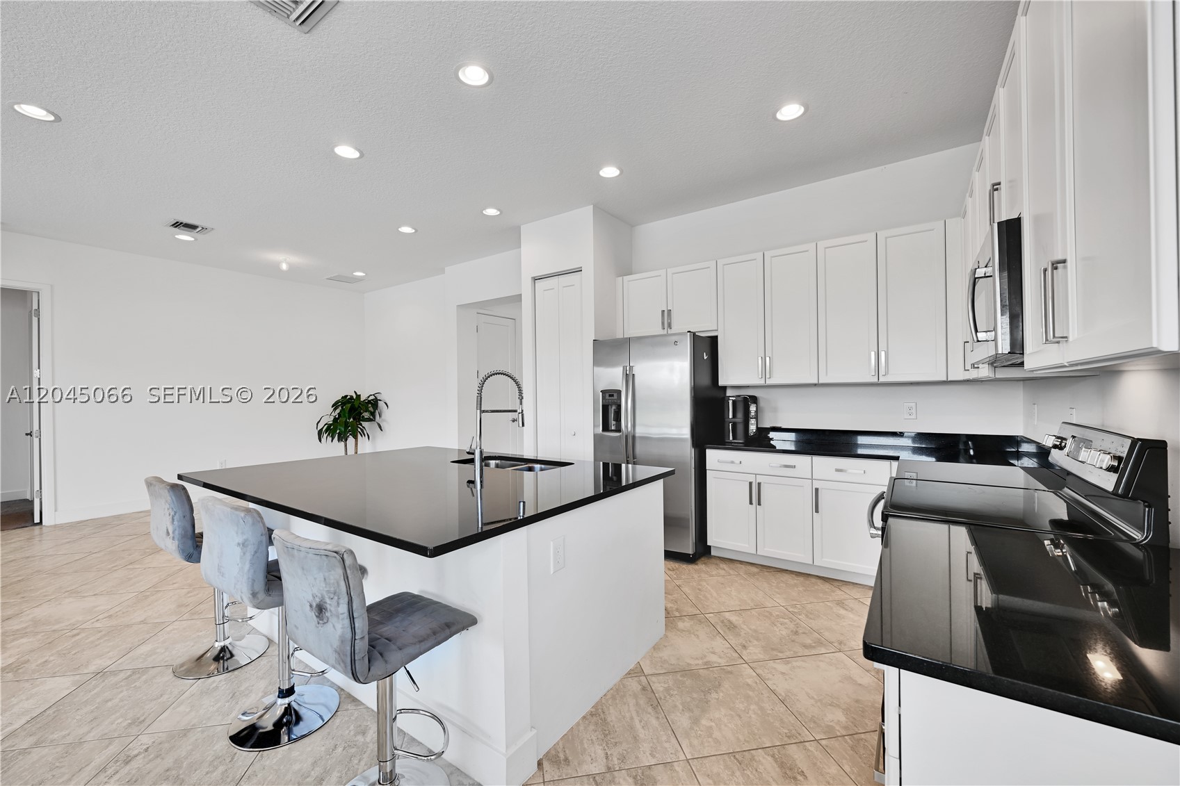 Highly desirable 3-bedroom + den floor plan in the prestigious Dakota community. This beautifully maintained residence showcases elegant designer touches throughout, including porcelain tile flooring in the main living areas and carpet in the bedrooms. The white chef’s kitchen features stainless steel appliances, cooktop, custom pantry, and a built-in bar area. The private backyard oasis includes a saltwater pool, marble decking, pet-friendly turf, eat-in bar, motorized screen, and upgraded paved walkway. Additional highlights include a sealed driveway with grill access, commercial-grade security cameras at all entry points, smart lock and Ring system, Wi-Fi extenders throughout, and double safe racks.