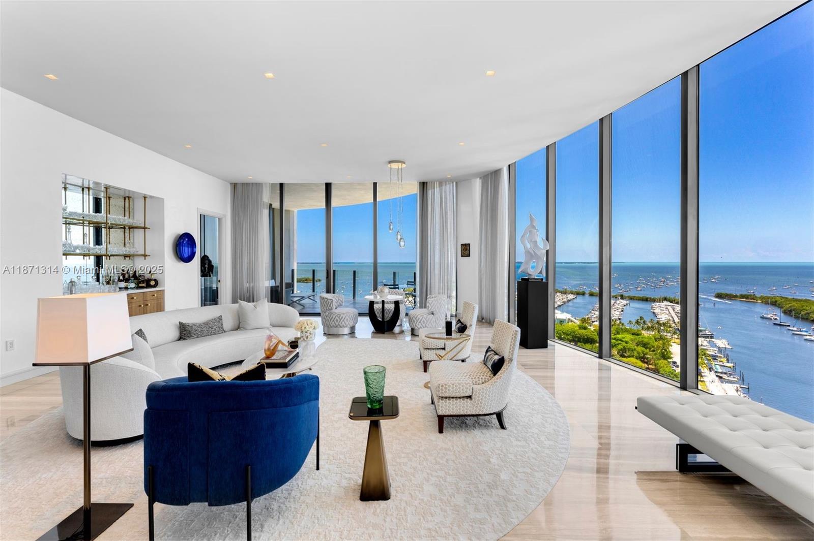 Designed by Pritzker Prize–winning architect Rem Koolhaas/OMA, One Park Grove defines luxury living. This rare 4-BD, 4.5-BA combined residence spans 5,257 SF with 2 private elevators and coveted A & B line positioning. Enjoy unobstructed sunrise-to-sunset views of the ocean and Biscayne Bay from floor-to-ceiling windows and expansive terraces. The renovated home features a principal wing with custom-made en suite closets and spa-like bath, a gourmet eat-in kitchen with Italian cabinetry, premium appliances, and water filtration, plus high-end finishes including Venetian plaster, marble/wood floors, custom office, automated shades, and laundry/utility room. Includes 2 garage spaces and an 8x19 storage room. Resort-style amenities: bayfront pool, spa, fitness center, screening room & more.