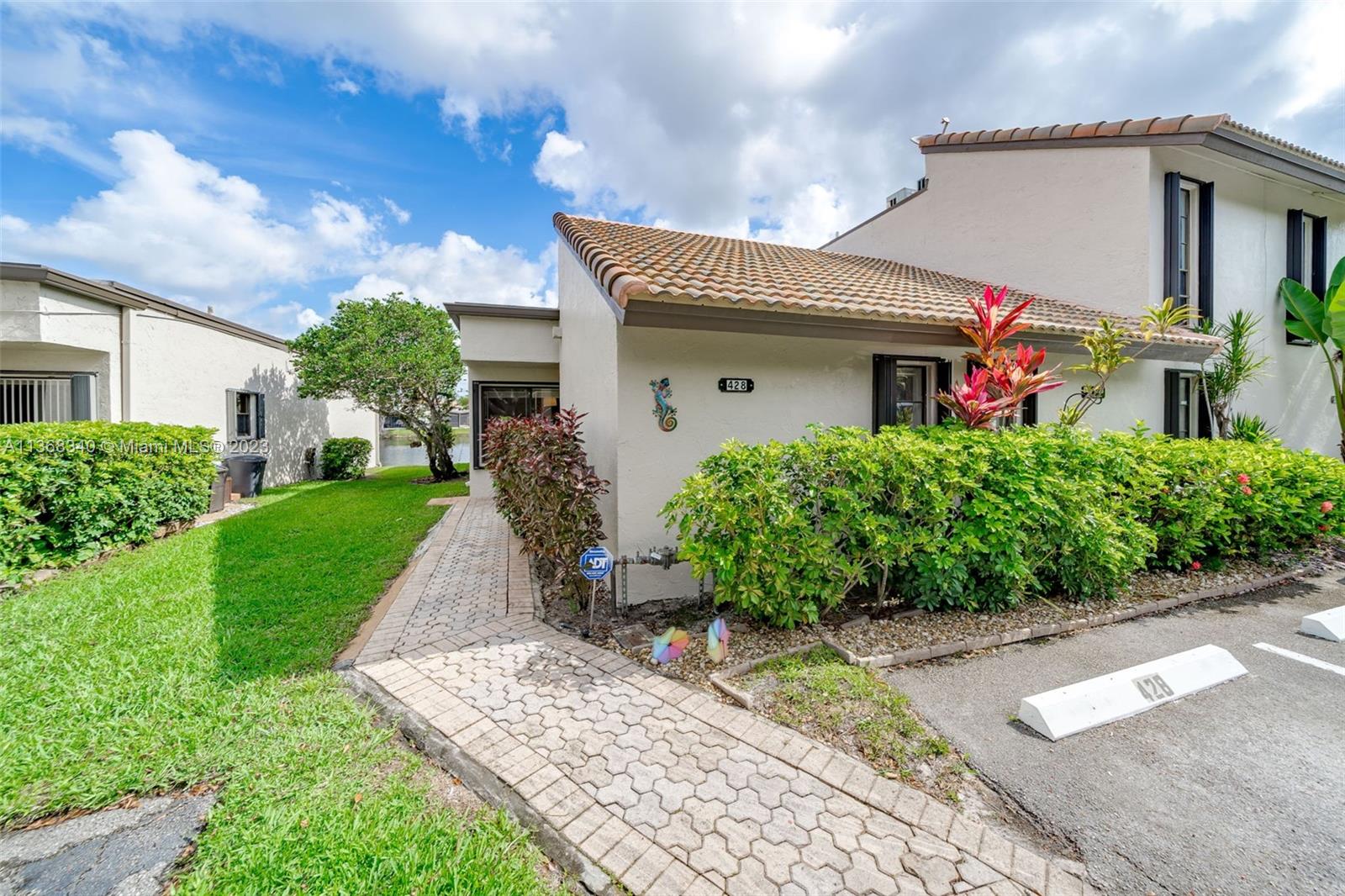 Opportunity knocks to own a rarely available 3 bedrooms, 2 baths, 1677sq.ft, single story, waterfront, corner lot Villa with beautiful and expansive water views in The Trellises of Jacaranda East Plantation. 
Spacious living area highlighted by vaulted wood-beamed ceilings. Large eating kitchen with S.S appliances, granite countertops, nook and pantry. Separate laundry room w/full size washer and dryer. Split bedroom floor-plan has oversized rooms and lots of closet space.  Master bedroom with his and hers walk-in closets and amazing water views. Updated bathrooms. Unit radiates with natural light. Newer roof (2016), A/C( 2020)  water heater(2022). Two designated parking spaces directly in front. Accordion shutters. Enjoy breathtaking water views from your screened patio. A must see!!!