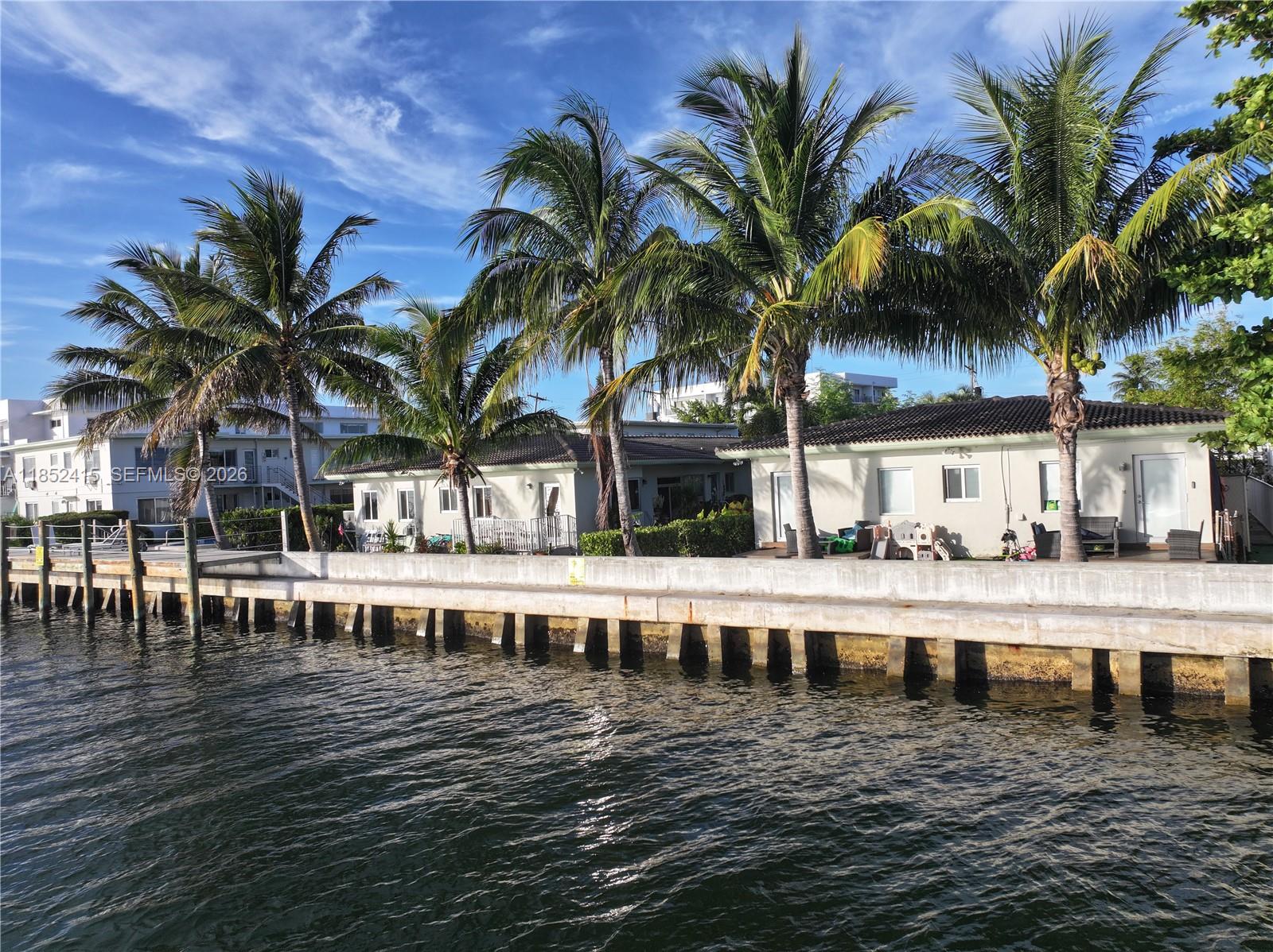 Investor Opportunity: Normandy Island. Enjoy stunning sunsets from this private 2-bed/2-bath, split-layout unit located on Bay Drive West, nestled on a quiet, no-outlet street. Could Rent for $3,000/month +/- fully renovated, or can be leased as-is for \$2,500/month +/-. Additional; low monthly maintenance, new seawall, dock, and pool, and the building has successfully passed the 40-year recertification, ensuring structural integrity and compliance. Near Golf, tennis & kid parks, safe community. Possible future developer land play opportunity with 2 four unit, single-level buildings and a 2 level building with 18-units, totaling 26 unit condominium. The entire property sits on approx. 35,000 SF with an impressive 220 feet of Biscayne Bay frontage. With $5 billion + in new construction underway in the area.