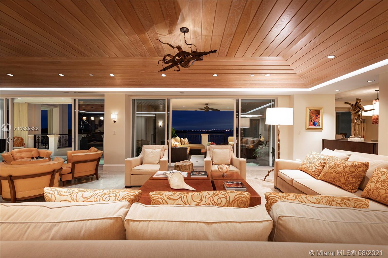 Sunsets, twilights & mesmerizing moons captivate the senses in this perfectly renovated 6700sf high floor unit on Fisher Island. No other location offers unobstructed Miami skyline views from the sprawling LVG areas and continuous deep covered terraces.  Best views of South Beach frm east terraces and back BRs. Featuring a true den/office, spacious home gym w/ sauna, marble & Chicago Oak wood floors, wood accented ceiling in the LVG room accentuating its height & volume. Impact glass doors & windows, Crestron system for custom security & ambient light setting. CentralVAC, sophisticated wet bar & wine cooling. Expansive master bath boasts luxurious rain shower, sep His/Hers dressing areas & generous walk-in closets. But it's the calming waterfall & spa jacuzzi that steals the scene.