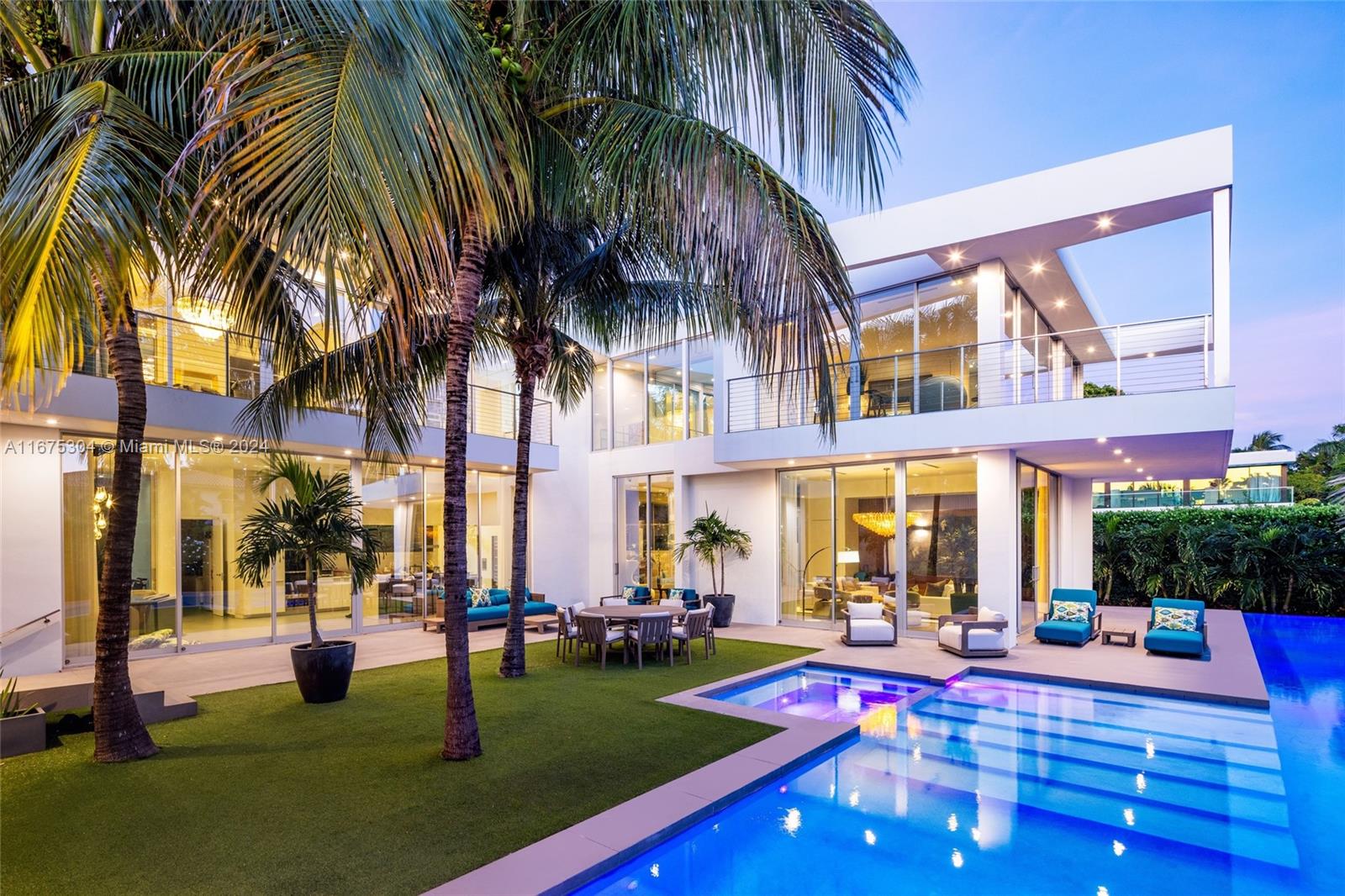 Indulge in the epitome of luxury living with this stunning modern masterpiece on an expansive corner lot in guard gated Hibiscus Island. This architectural gem exudes sophistication, with its flawless design, soaring ceilings, and floor-to-ceiling glass doors seamlessly blending the indoors with the outdoors. The gourmet kitchen is a chef’s dream with top-of-the-line appliances, bespoke cabinetry, and elegant finishes. The primary suite is a private sanctuary with a spa-inspired ensuite bath, dual oversized closets, and serene views. The outdoor space is an entertainer’s paradise with a sparkling pool and expansive lounge areas perfect for al fresco dining. A private guest house adds exclusivity. Residents enjoy premier amenities, including a park, tennis/basketball courts, & playgrounds.
