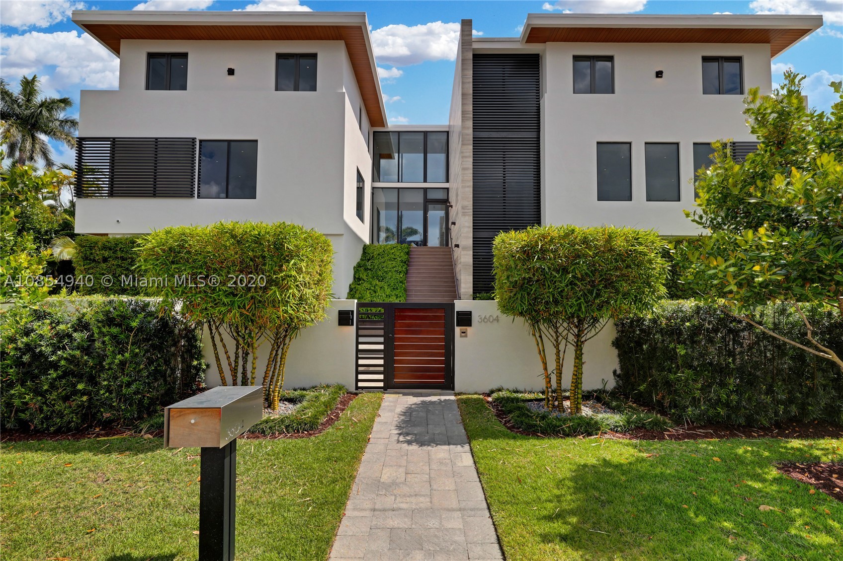 Spectacular contemporary 6 bedroom / 6 1/2 bath Coconut Grove waterfront house, with independent guest house. This 2017 new construction sits on a peaceful waterway, 600 feet from Biscayne Bay, in the private & guard-gated community of Entrada estates. Enjoy the luxury of living on the water, in a peaceful community where neighbors share a tennis court & a small dog park at the end of the road. The house offers large volumes, high ceilings, & abundant natural light pours in. The high windows offer views on the lush tropical landscaping, & waterway. The house is equipped with an elevator, an inside & outside sound system controlled with the same panels as security & A/C throughout the property. The floors are a combination of polished stone in common areas & wood in the bedrooms.