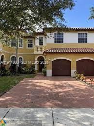Beautiful townhome with a patio, garage, and driveway! FANTASTIC Price. HOA approval takes only 2 weeks. This home is beautiful!! It was originally a 3-bed, but the upstairs master bedroom, powder room, and bathroom now offer a large master suite with plenty of closets and space! The laundry room, yes, a room, is upstairs and includes an extra-capacity washer and dryer. The kitchen features modern colors and schemes, and the unit has been completely remodeled. No property behind it, nor in front of it. Townhome has Impact windows and doors! The layout is inviting and sophisticated. Lots of natural light. The TV wall mount in the bedroom and the patio are staying with the property. Owners change filters and maintain the property. The backyard patio is ideal for entertaining and has no other residences behind it. The complex offers many amenities and is ideally located in Miramar next to Miami Lakes.  Plenty of street parking in front of the property. A MUST SEE to appreciate. Call today and make an appointment to see this incredible remodeled unit.