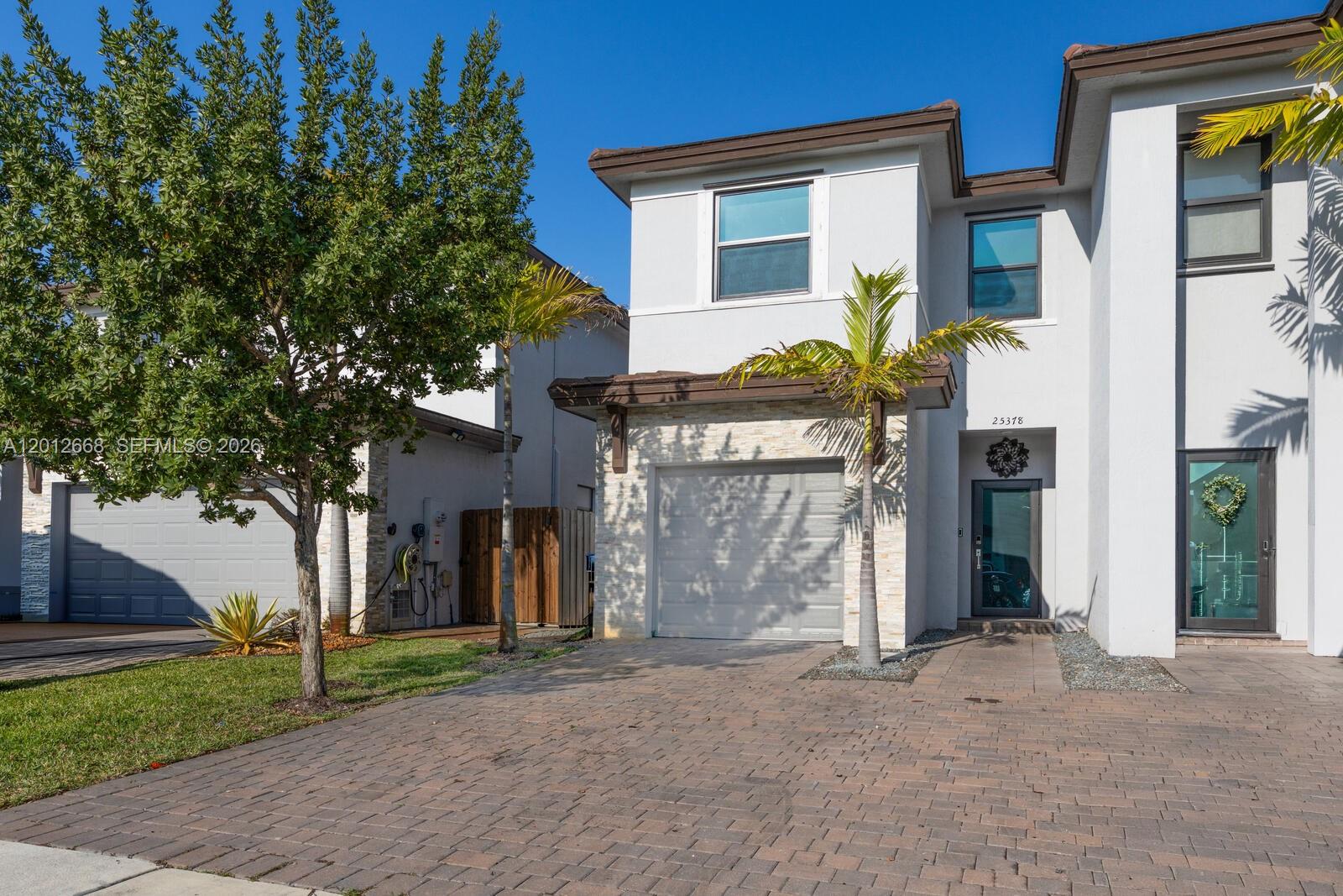 Stunning 3-bedroom, 2.5-bath twin home offering the perfect blend of style, space, and comfort! This beautifully maintained property features high ceilings and abundant natural light throughout, creating a bright and inviting atmosphere. The modern kitchen boasts a huge island, perfect for entertaining, along with ample cabinetry and modern finishes. Enjoy tile flooring on the main level and wood laminate upstairs, along with plenty of closet space for all your storage needs. Step outside to a spacious fenced backyard complete with a pergola and stamped concrete terrace—ideal for relaxing and hosting gatherings. Additional highlights include impact windows and doors, a one car garage, resort style community amenities, and a prime location close to major highways, top-rated schools, shopping, and dining. A true must-see and easy to show!