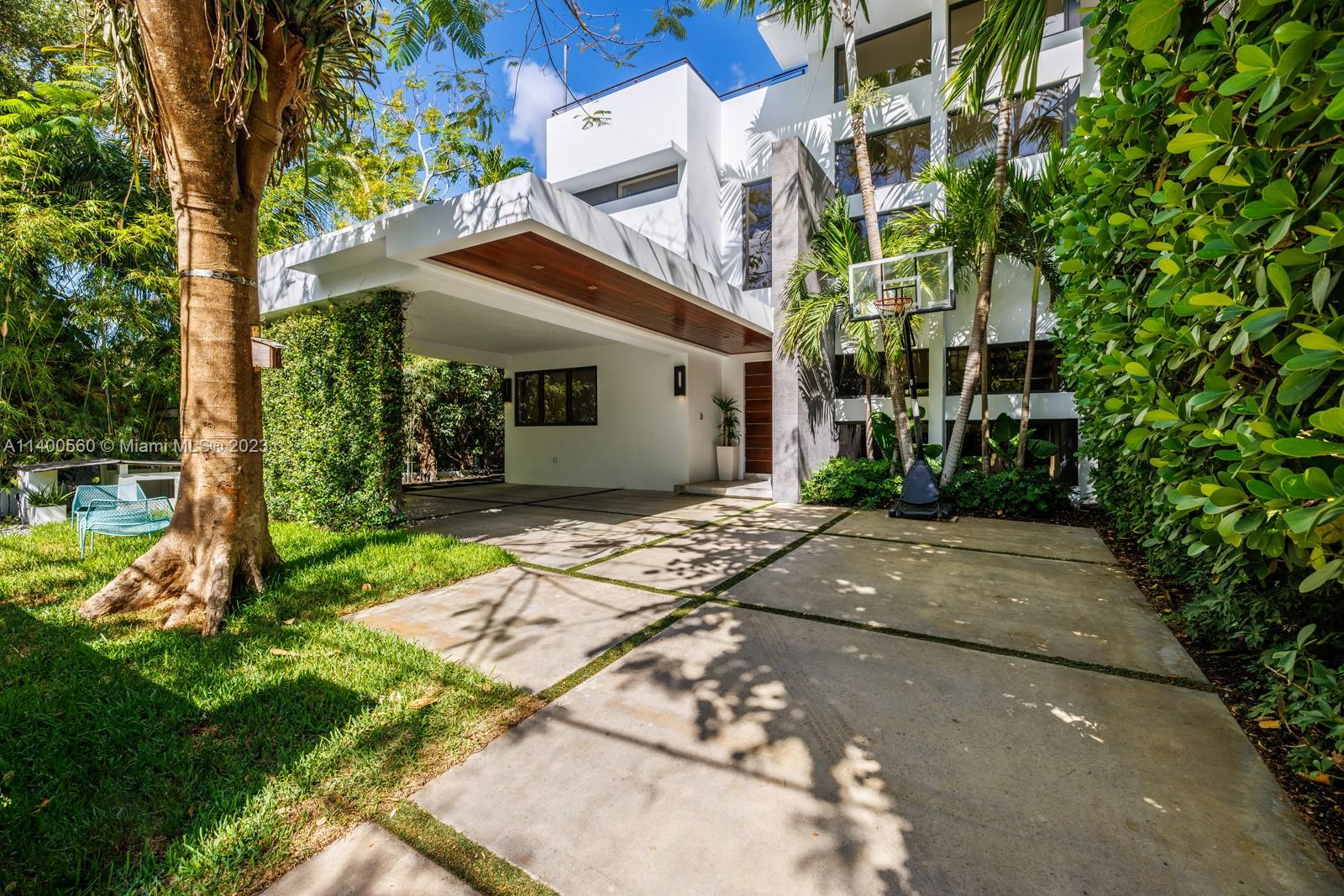 Stunning, Tropical modern home in prestigious North Coconut Grove. Totally gated and located on a quiet tree- canopied street, just a short walk or bike ride to bayfront parks & marinas. Designer finishes throughout including stone & wood flooring, volume ceilings, custom built-ins + chef's kitchen with Italian cabinetry & Subzero/Wolf appliances. Expansive primary suite offers spa-like bath w/soaking tub & frameless glass rain shower. Additional notable features: elevator, impact glass throughout, 48kw whole house generator, floating staircase and large family overlooking tropical pool & covered terrace. Lush landscaping surrounds the home and the rooftop terrace offers panoramic views of the Grove & beyond. Minutes to downtown, MIA, Coral Gables, Key Biscayne & the Beaches.