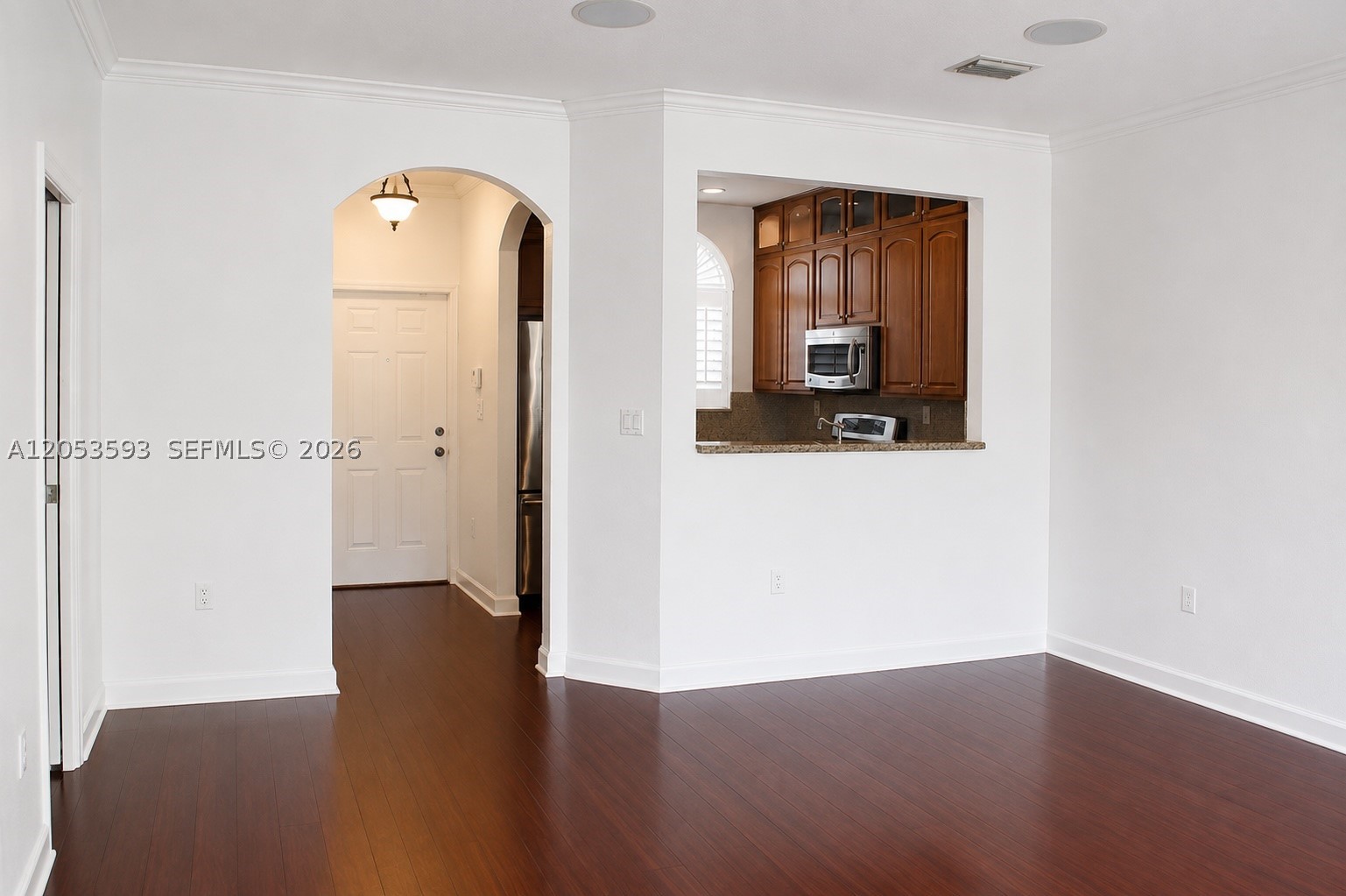 Move right into this beautiful home featuring bamboo flooring, soaring volume ceilings, elegant crown molding, and a bright open-concept layout designed for today's lifestyle. The stylish kitchen offers LG stainless steel appliances, including a self-cleaning convection oven, granite countertops, and overlooks the main living area with built-in ceiling speakers—perfect for entertaining. French doors open to a private, fully fenced backyard, ideal for relaxing, grilling, or pets. The spacious primary suite features a custom-designed double closet for exceptional storage. Located in a beautifully maintained gated community with easy access to shopping, dining, parks, schools, and major highways. Move-in ready —schedule your showing today!