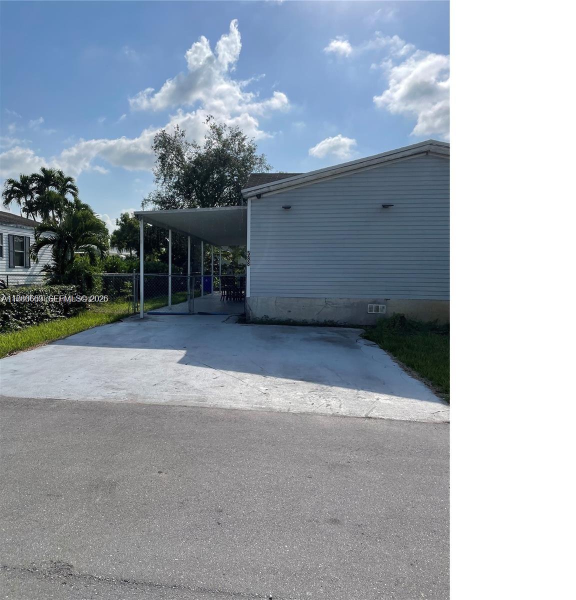 Spacious double-wide manufactured home featuring one of the largest floor plans in the community. This property offers a desirable split-bedroom layout with 4 bedrooms and 2 updated bathrooms, providing functional living space and added privacy. The primary suite includes a large bathroom. Interior features include a separate laundry room, newer water heater, and recently replaced roof.
