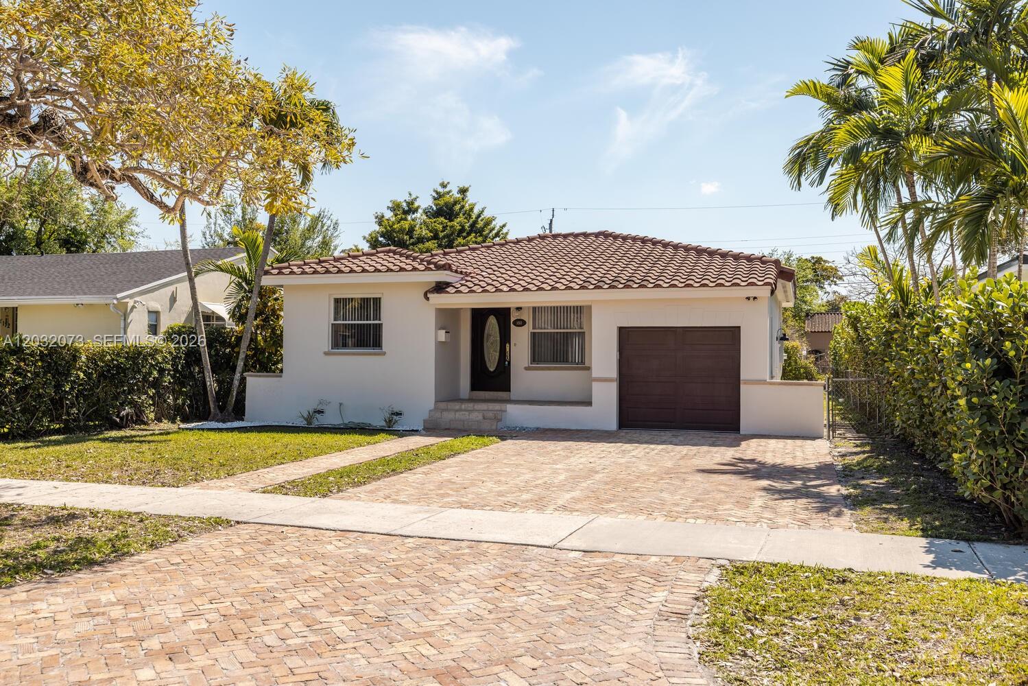 Welcome to Casa Carlisle in Miami Springs! Tucked away on a peaceful, tree-lined street, this beautifully updated 2-bedroom, 1-bathroom home with a one-car garage offers modern living with a bright, airy feel. Pass through the charming front porch into open-flow living and dining, where French doors lead to a sprawling backyard-- perfect for relaxing and entertaining. Thoughtfully updated with all impact windows, a sleek all-white kitchen featuring new stainless steel appliances, and a stunning spa-like bath with a walk-in glass shower. Ideally located just minutes from the airport, major highways, and the vibrant shops and restaurant of downtown Miami Springs. Don't miss the opportunity to make Casa Carlisle your own!