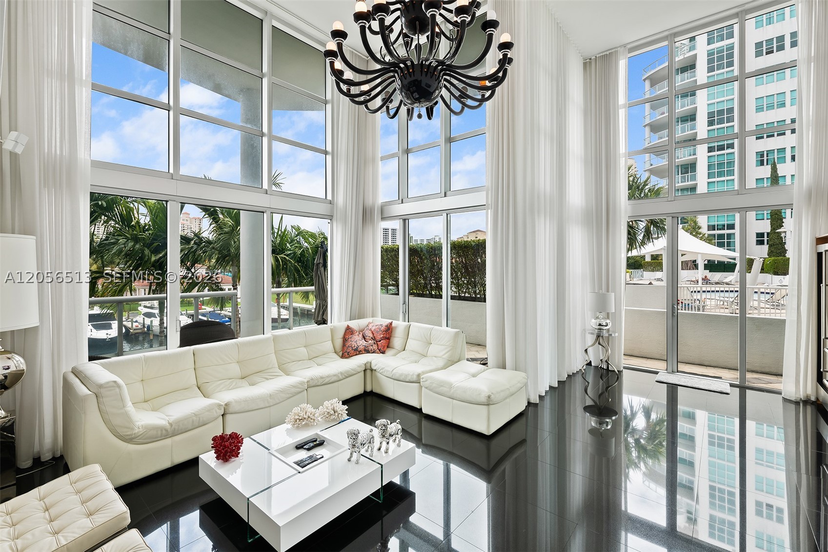 One-of-a-kind two-story residence featuring 5 bedrooms, 3.5 bathrooms, and a loft in the heart of Aventura, just moments from premier dining, shopping, parks, and entertainment. The first level showcases elegant black marble flooring throughout, an open-concept kitchen, spacious living and dining areas, and two bedrooms with direct access to a private patio. The second level features warm wood flooring, an expansive primary suite with a private terrace overlooking the canal, an oversized walk-in closet, and an en-suite bathroom, plus two additional bedrooms and a versatile loft. The oversized terrace extends the living space and creates the feel of having the pool as your own backyard. Includes three assigned parking spaces, one equipped with an EV charger. Atrium residents enjoy exceptional amenities, including 470 feet of waterfront, a marina with slips accommodating vessels up to 60 feet, resort-style pool and spa, fitness center, sauna, steam room, club room, children's playground, business center, and valet service.