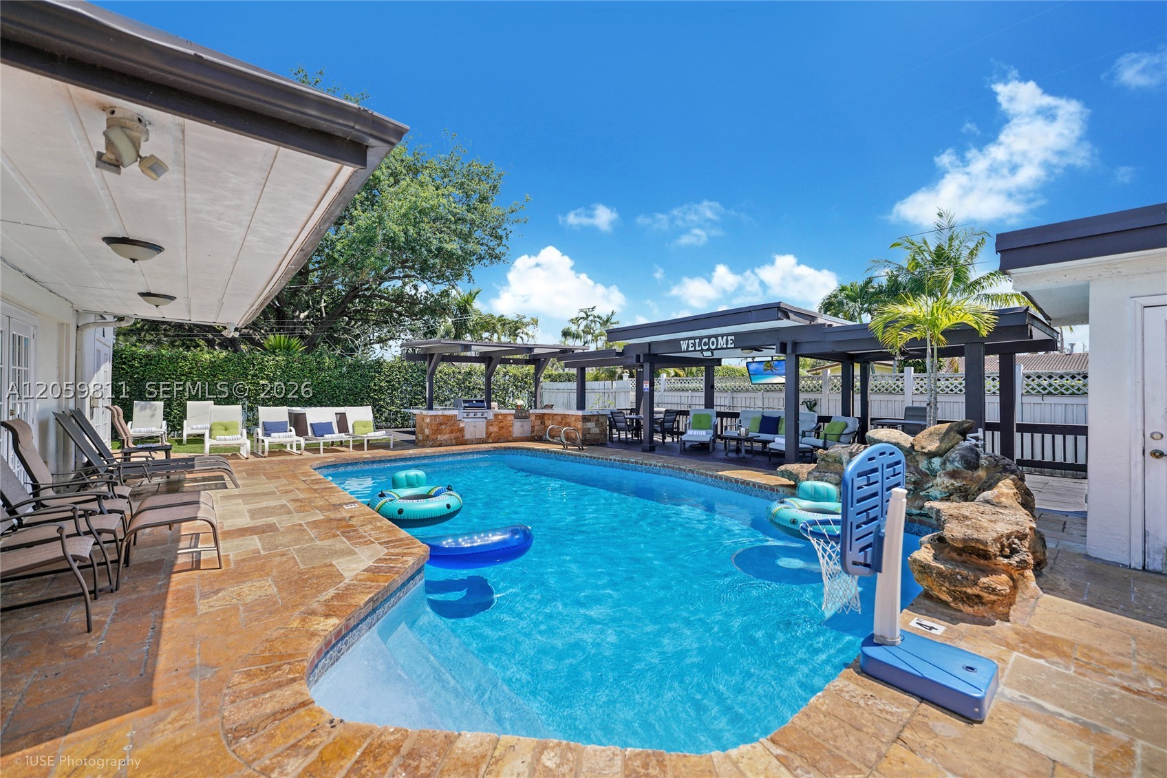 Discover the ultimate resort-style lifestyle in Hollywood Hills, Florida! This exceptional private resort offers 2,840 sq. ft. of air-conditioned living space and approximately 3,499 sq. ft. of combined indoor and covered living and entertainment areas. The versatile layout features 5 bedrooms and 4.5 bathrooms, including two private en-suite bedrooms offering excellent comfort and privacy. The flexible fifth bedroom can also function as a family room, office, media room, game room, or additional entertainment space.

Step outside into a tropical paradise designed for year-round enjoyment and unforgettable gatherings. The spectacular backyard features an oversized covered gazebo, heated pool, hot tub, outdoor kitchen, covered dining and lounge areas, and multiple entertainment spaces surrounded by lush landscaping and privacy. Whether relaxing by the pool or entertaining under the stars, this private resort delivers the ultimate South Florida lifestyle.

Ideally located near the Hard Rock Hotel & Casino, beaches, Downtown Hollywood, shopping, dining, highways, and Fort Lauderdale–Hollywood International Airport. Perfect for a family seeking a private resort or an investor looking for a turnkey property currently operating successfully as a short-term rental. Schedule your private tour today!