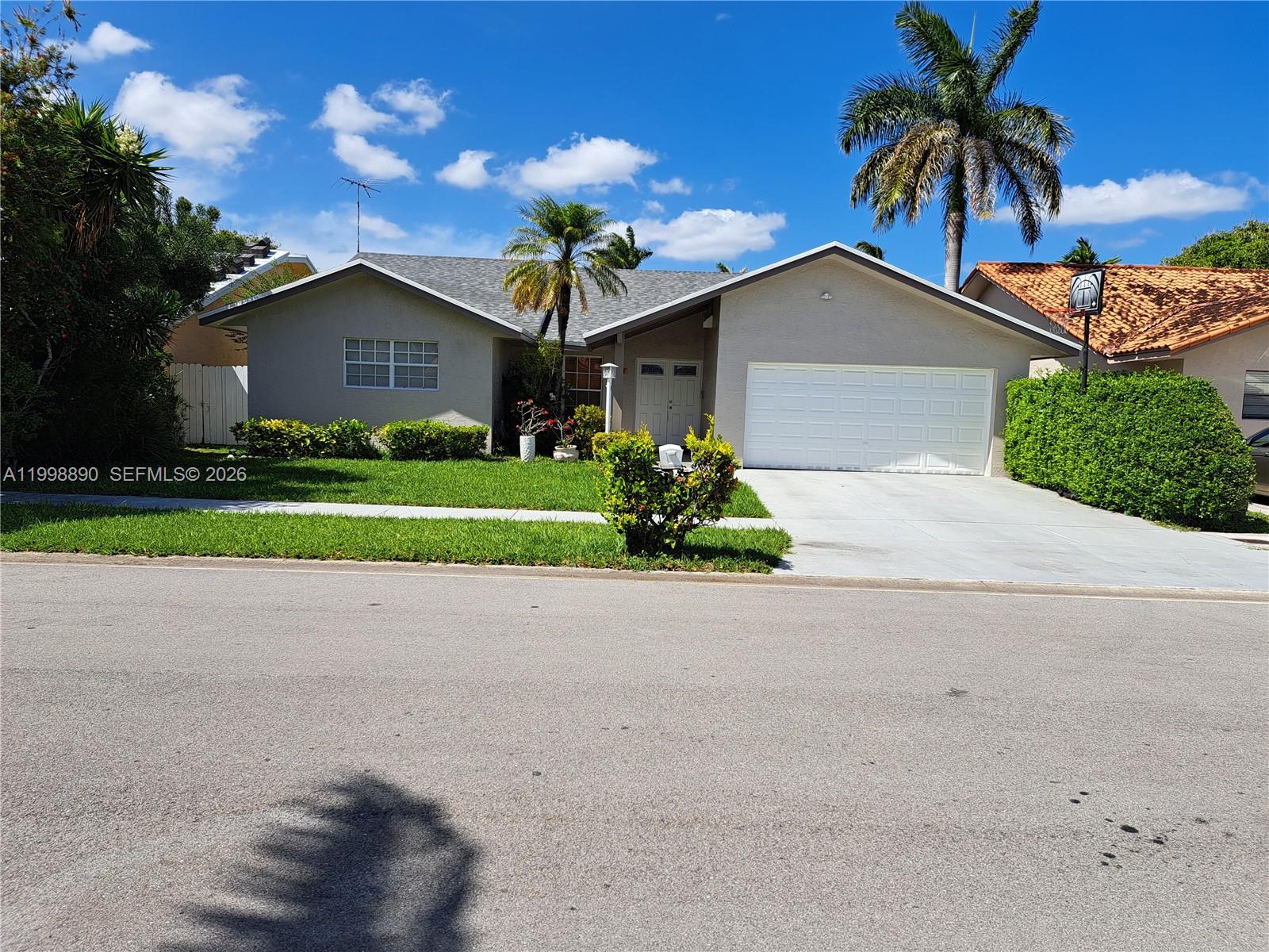 Your dream home awaits! This meticulously maintained Single-Story property shines with a brand new roof, 2-car garage, and NO HOA! Inside, you'll find an exquisite European-Style kitchen with upgraded appliances, custom-designed bathrooms, and sophisticated oversize porcelain tile throughout. Offering 4 bedrooms and 2.5 baths, convenience, plus a generously sized living and open dining area that exceeds tax roll records (permitted). This home provides ample space for comfortable living for a larger household. The master bathroom is designed for relaxation, complete with a Jacuzzi Tub and a separate glass-enclosed shower. The aroma from jasmine trees provides privacy for the outside spacious backyard and patio, creating a serene ambiance, complemented by some hurricane impact windows and an elegant impact front door for enhanced safety. Experience the convenience of suburban living just minutes from top-rated schools, grocery shopping, major hospitals, and main highways. Price reduction for quick sale—call for your exclusive showing by appointment only! Easy to show.