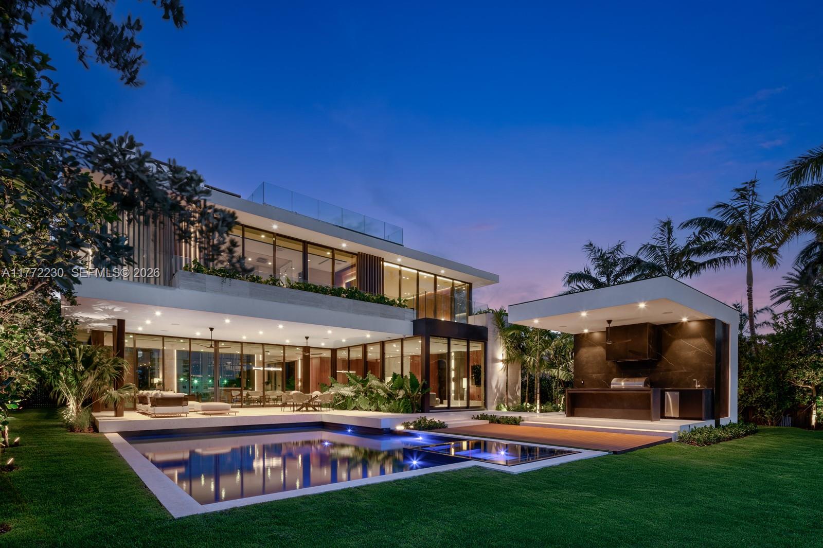 Masterfully designed by SDH_Studio, developed by Groupe Dayan & built by Treo Construction in 2025, this architectural masterpiece spans 7,000 sqft, with 7 beds and 7+ baths, of luxury. Minotti furnishings define its contemporary elegance, where sculpted architecture plays with light and shadow. Soaring ceilings, a striking floating staircase, and voluminous spaces create grandeur. A floor-to-ceiling wine cellar with integrated bar reinforces the home's scale. Stone accents elevate the interiors, notably in the kitchen, where a stunning island is paired with top-tier appliances. Custom millwork, walnut paneling, and bespoke lighting add warmth and refinement. Outside awaits a waterfront oasis with pool, outdoor kitchen, and 78 ft of waterfront with a new private dock.