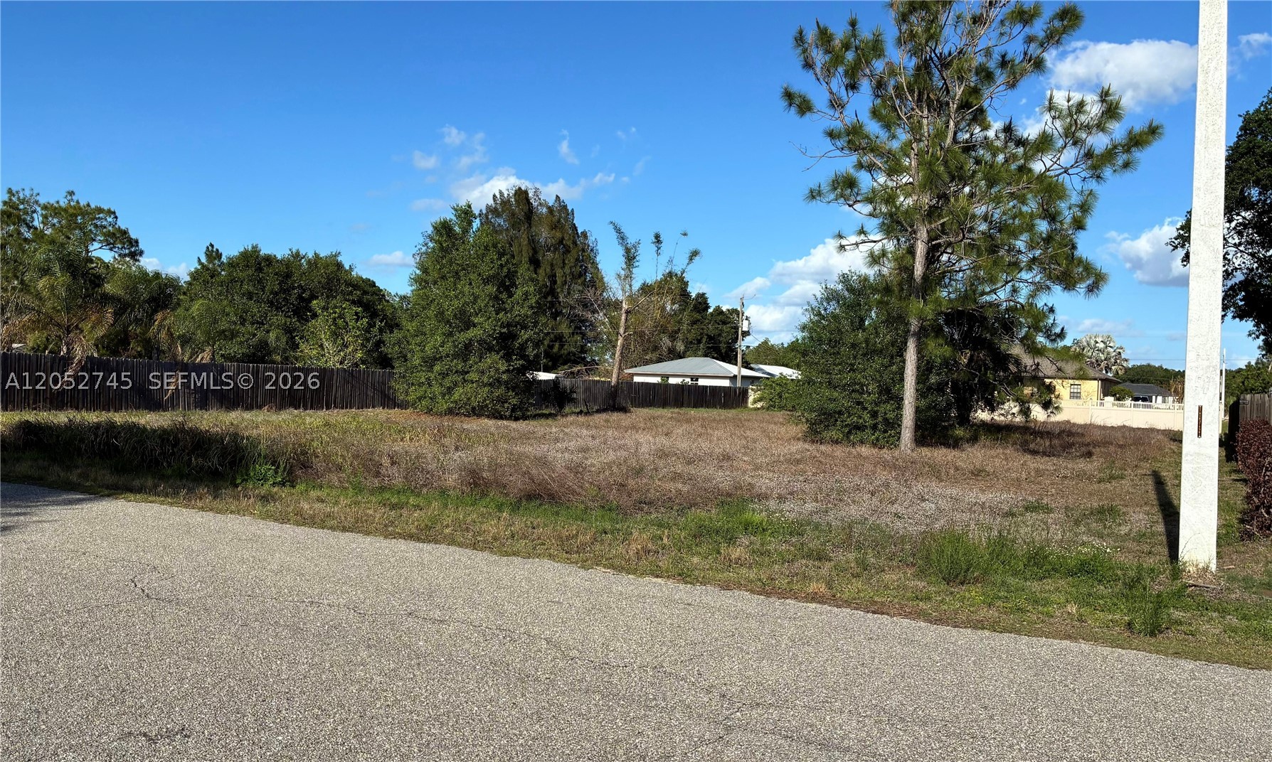 Beautiful residential lot located in Lehigh Acres. This 0.50-acre property offers plenty of space to build your dream home. Located on Robert Ave with easy access to major roads, shopping, schools, and nearby amenities. Great opportunity for investors or future homeowners. Utility pole visible near the rear of the property behind the fence. Buyer to verify all information with Lee County, including utility availability and connection requirements with the appropriate utility provider.
