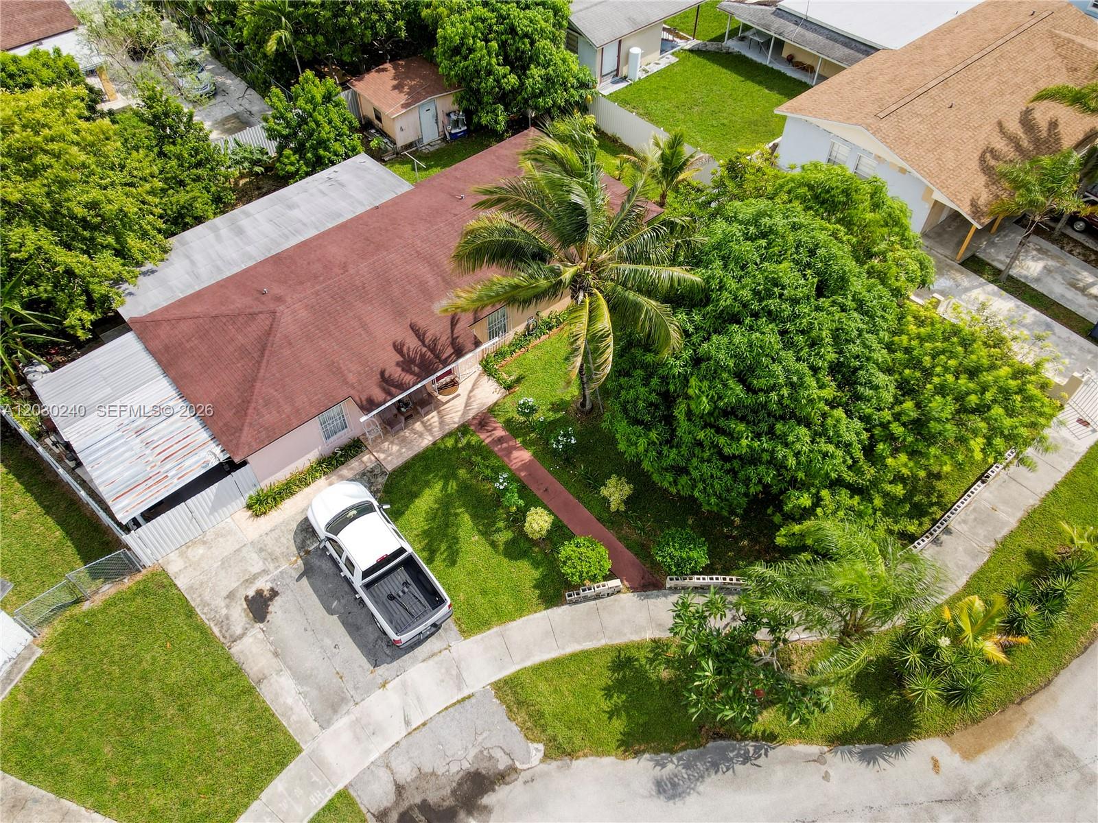 Plenty of living space with 2,127 sq ft! Lot is 8,750 sq ft. New roof installed in 2018, new A/C from 2019, and a new water heater provide peace of mind for years to come. 4-bedroom, 2-bath single-family home with no HOA.
Located on a quiet cul-de-sac. Each bedroom offers a walk-in closet which is rare. The updated kitchen features stainless steel appliances and a washer/dryer in a dedicated laundry room. The large family room, separate from living and dining room, provides plenty of space for gatherings or privacy. Create a 5th bedroom if needed. Dual central A/C units allow for comfort and efficiency. Enjoy a fenced backyard with mature fruit trees including mango, plantain, mamey, jobo, coconuts, and more. Use the well pump to water the plants and save money.  Also includes a storage shed and a covered deck with space for a vehicle. Drive way fits multiple cars. Near schools, shopping, restaurants, and the Turnpike for easy commuting. Property has low utility bills. Exterior was recently pressure cleaned and paint touch up after photos. Owners have maintained the property well.