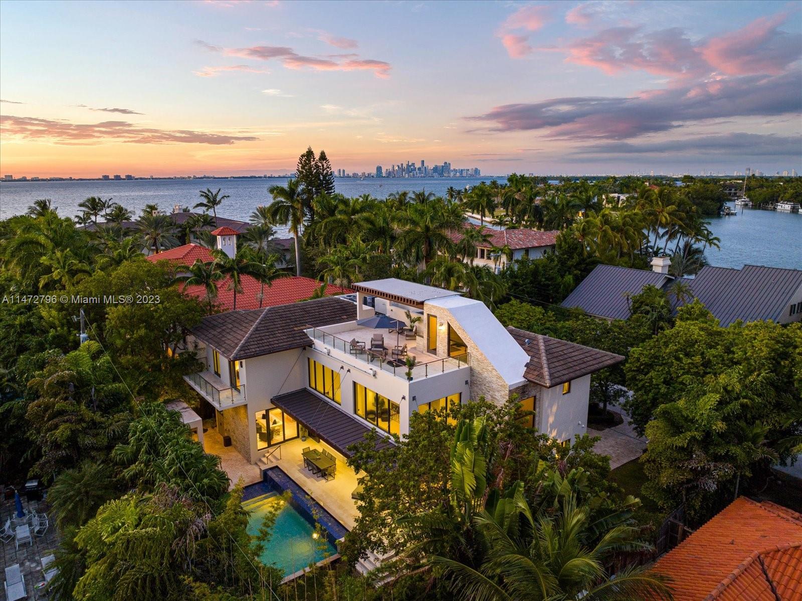 Your Key Biscayne Private Oasis on exclusive Mashta Island. This 6-bed, 6.5-bath modern masterpiece spans 4,225 SF on a 10,000 SF lot. The open floor plan and soaring 21’ ceilings fill every corner with light. Grand living is enhanced by telescopic sliding doors, creating a seamless flow with the outdoor area. Formal dining room is separated by elegant 288-bottle glass wine vault. Gourmet kitchen with gas stove, Miele and Bosch appliances, wine cellar, porcelain and quartz countertops, and kitchen bar. Enjoy Miami’s breathtaking sunsets from rare find 3rd floor rooftop terrace. Lush garden, with heated pool, jacuzzi, cabana bath and BBQ gazebo. Additional office, Sonos, laundry room, storage and a 2-car carport garage. Key Biscayne is a 10 min drive to Downtown and 25 min to the Airport.