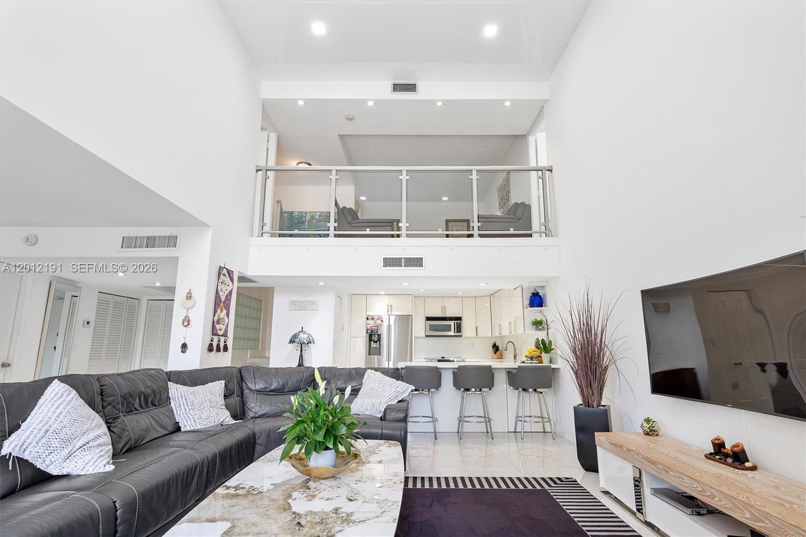 Enjoy the Space of a House at a Condo Price in Prime Aventura. This beautifully remodeled 2,500 sq ft townhome-style residence features vaulted ceilings, oversized windows, and abundant natural light with peaceful golf course and water views. The open-concept kitchen offers modern finishes, ample storage, and flows seamlessly into the living and formal dining areas—ideal for both entertaining and everyday living. The layout includes 2 split primary suites with sitting areas, 3 full bathrooms, and a versatile den that can easily be used as a 3rd bedroom or office, along with 3 private balconies. Additional highlights include a new A/C, new water heater, and covered garage parking space just steps from the entrance. The community offers a heated pool, fitness center and spa for added comfort and convenience. Located in the heart of Aventura, within walking distance to Aventura Mall, dining, shopping, parks, and top-rated schools.  Ideal for a primary residence or second home. Move-in ready!