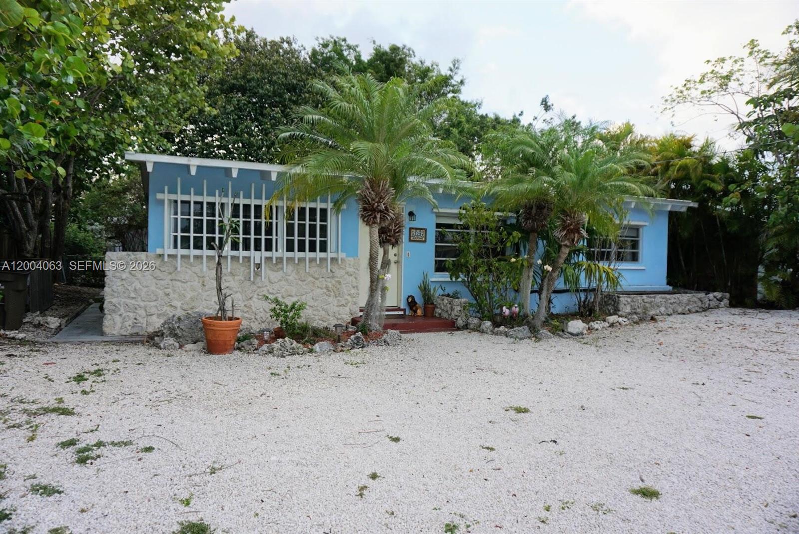 Welcome to this charming Key Largo residence located at 229 2nd Rd. This delightful home is nestled amongst a tranquil hammock setting with beautiful views and a refreshing breezes suited for a family or a split shared living space. Made of durable construction, this home comes equipped with a metal and concrete roof. Each room has a private bathroom and ample living space. The property features spacious living areas, high ceilings, unique island accents, modern finishes, and abundant natural light throughout. Enjoy the a spacious yard filled with natives and shading trees, great  for privacy and keeping cool in the summer. with a back yard  that is spacious enough for entertaining and peaceful enough for some relaxation, you'll be sure to find some island time. The front bedroom can be converted into a convenient mother -in-law suite with private entrance on the side of the main house. With several convenient entryways into the house, you'll fall in love with the possibilities. The backyard boast several planting boxes in the sunniest areas, a gardeners dream! Close to elementary schools, bus stops, and a community boat ramp with attached dog/community park complete with trailer parking for residents. Conveniently located near local amenities as well as mainland Florida for easy access to Miami nightlife or shopping and convenient travel from Miami airport. This home provides a superb blend of south Florida and keys coastal living. Don't miss the opportunity to experience this wonderful property.