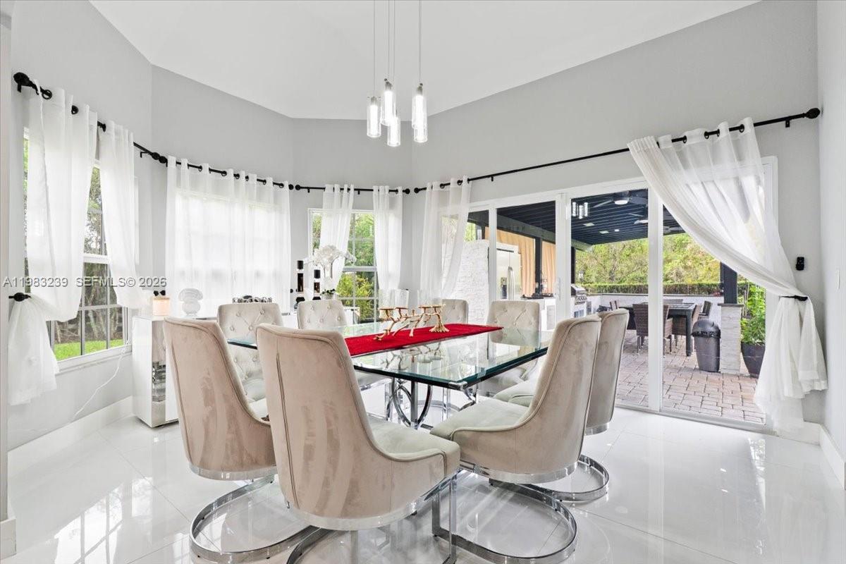 NEW LISTING! Completely remodeled with a sleek, modern design, this exceptional residence offers luxury, comfort, and outstanding functionality on one of the area's most desirable streets.
The dramatic great room welcomes you with soaring wood ceilings and a brand-new floor-to-ceiling stone fireplace, creating a warm yet sophisticated focal point. The main level features elegant porcelain tile flooring, while the upper level showcases beautiful tile flooring, offering durability and a clean, modern look throughout.The expansive first-floor primary suite includes a private sitting area and a luxurious spa-style bath designed for ultimate comfort. Upstairs you will find three additional spacious bedrooms plus a large loft, which can easily be converted into a fifth bedroom, office, or media room.
Designed for comfort, security, and efficiency, the home includes all impact windows and doors, three-zone A/C systems, a powerful 45KW whole-home standby generator, newer whole-house water system, and one well.