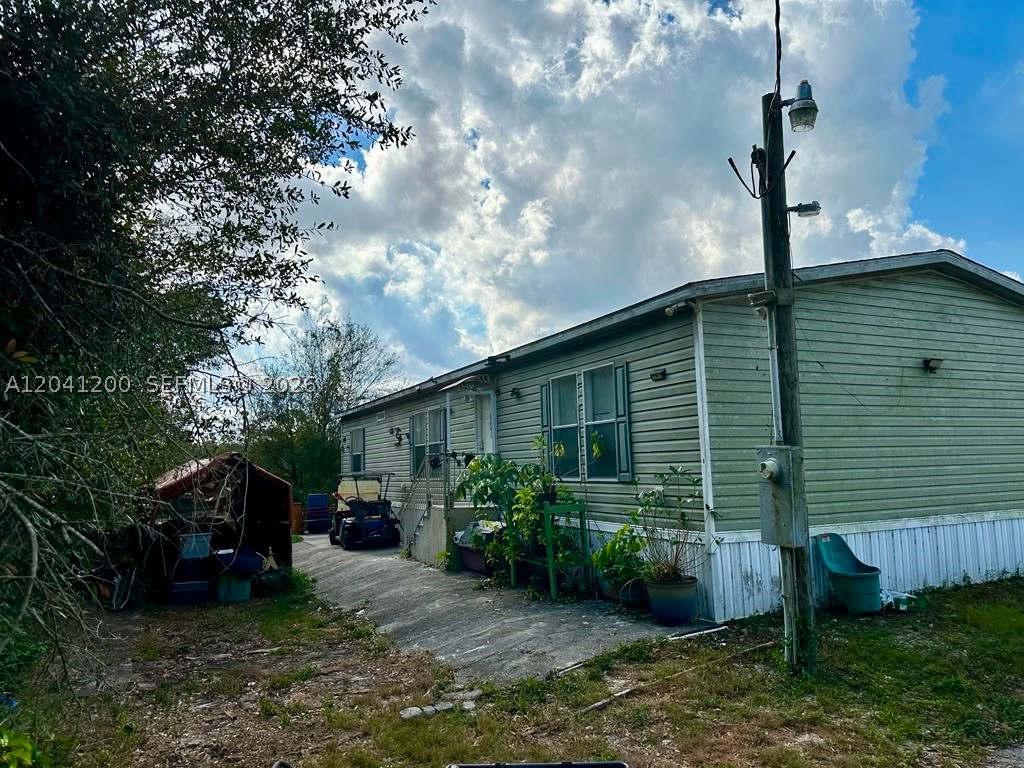 Enjoy country living on this 1.25-acre fenced property with a 3-bedroom, 2-bath mobile home with plenty of open space and endless possibilities. The mostly cleared lot offers a functional layout with room for boats, RVs, trailers, work vehicles, gardening, livestock, or future expansion.   Whether you're looking for a primary residence, investment opportunity, or a place to enjoy the rural lifestyle, this property delivers space, flexibility, and value. No HOA restrictions.  (Some photos have been virtually staged to illustrate the property's potential. Virtual staging is for marketing purposes only and does not represent the current condition of the property.