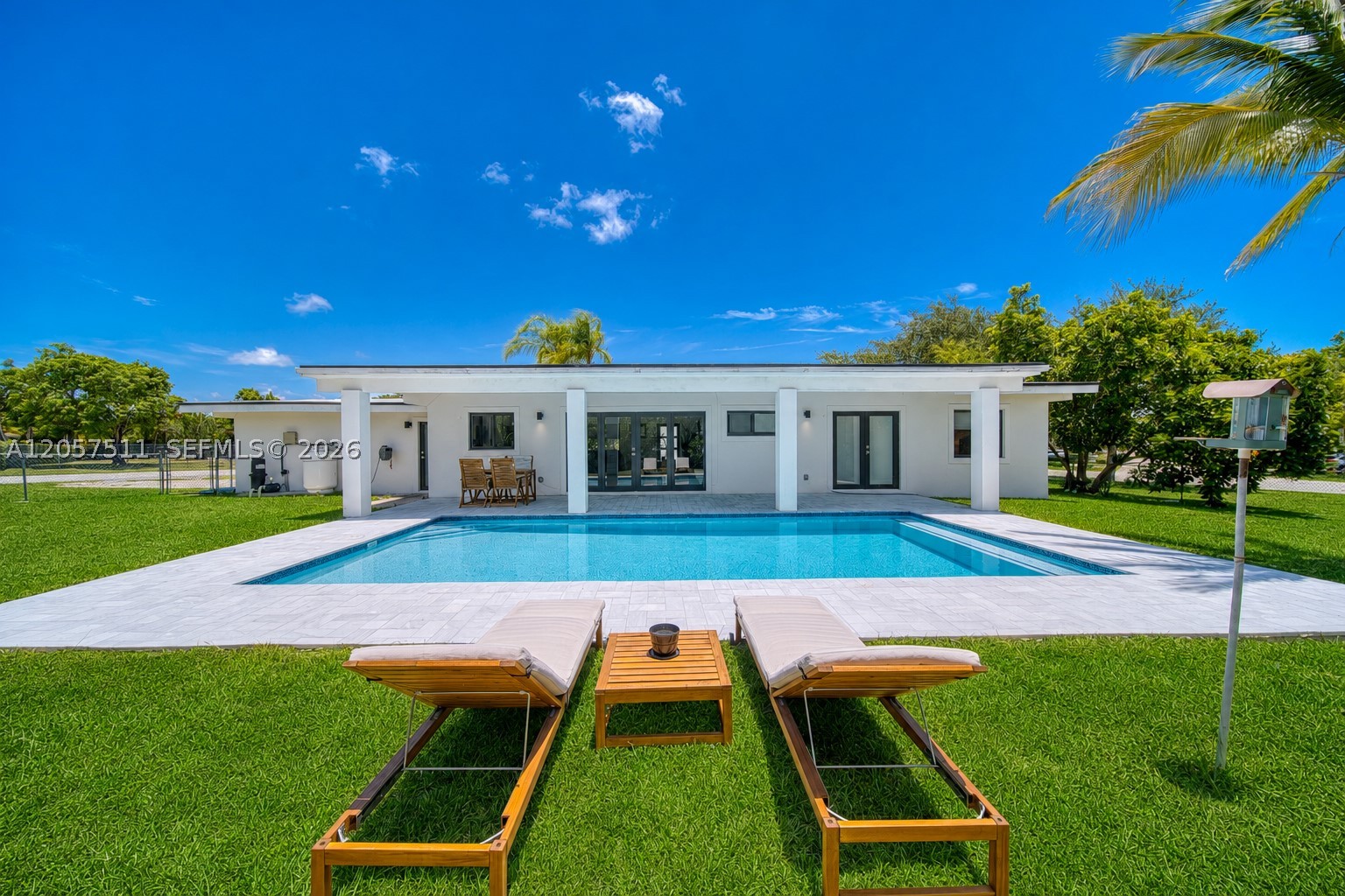 Pool home on an oversized corner lot in desirable Palmetto Bay. This beautifully renovated 3-bedroom, 2-bath home was completely rebuilt to the studs in 2023 and features a new roof, impact windows and doors, new plumbing, new electrical, and modern finishes throughout. The bright open concept layout features a designer kitchen with custom cabinetry, quartz countertops, stainless steel appliances, a gas range, and an oversized island overlooking the living and dining areas. Step outside to a covered patio, sparkling pool, spacious yard with avocado and coconut palms, creating the perfect setting for year-round entertaining. Spa-inspired bathrooms, generous bedrooms, and a two-car garage complete this move-in-ready home. A rare opportunity to enjoy modern style and exceptional indoor-outdoor living in beautiful Palmetto Bay.