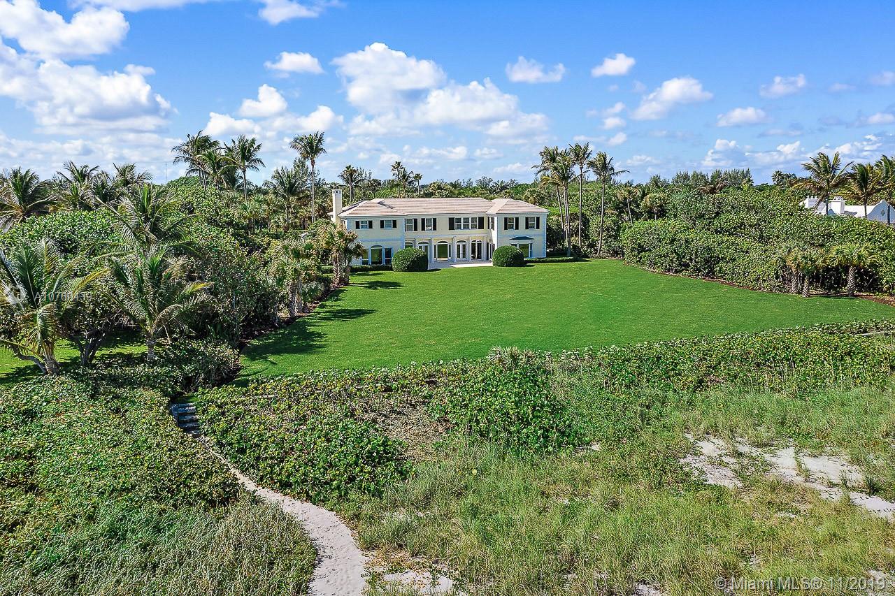 This spectacular oceanfront property sits directly on 187 feet of prime Jupiter Island beach frontage. The high elevation with deep and wide emerald green lawn offers unobstructed panoramic views of the turquoise Atlantic. The spacious, classic residence includes five bedrooms each with its own en-suite bathroom and enormous closets. There are numerous entertaining rooms all with ocean views to accommodate many family members and guests. Five car garage space.
