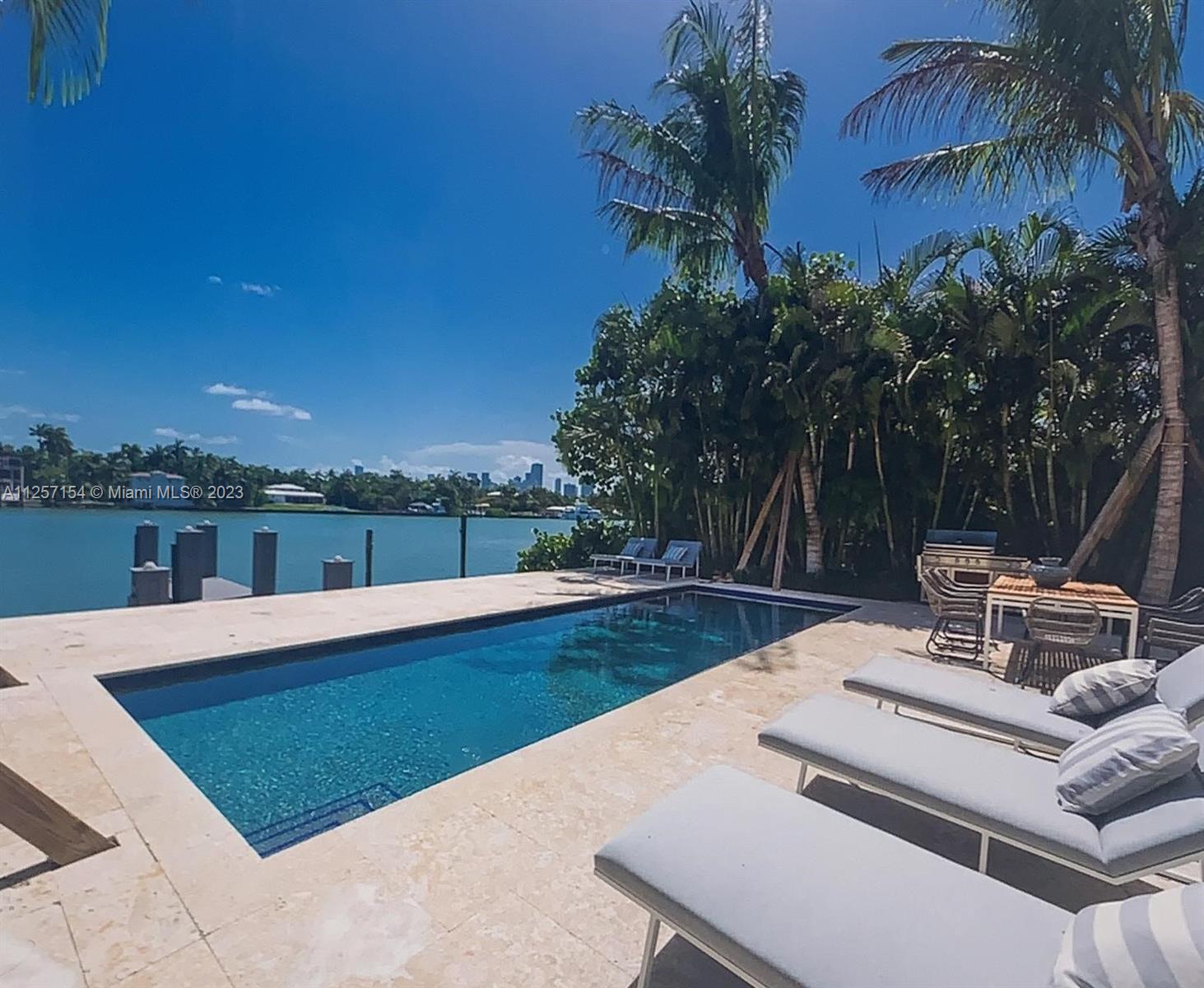 Once in a lifetime opportunity to have the city and island lifestyle! This home features 5 Bedrooms and 6.5 Bathrooms including a private guest suite with a separate entrance above the 2-car garage. This spectacular property is a perfect oasis, with breathtaking views, water access from a deck, a large backyard and pool, perfect for entertaining. The house includes a high ceiling, new impact windows and doors, a new open kitchen, custom home automation, and more. Brand new applicants from Miele, kitchen cabinetry and closets are exclusively designed by Ornare.  The island offers a waterfront park, tennis & basketball courts, playgrounds, and a 24-hour manned police officer at the main entrance, all within a short distance of the best Miami offers!