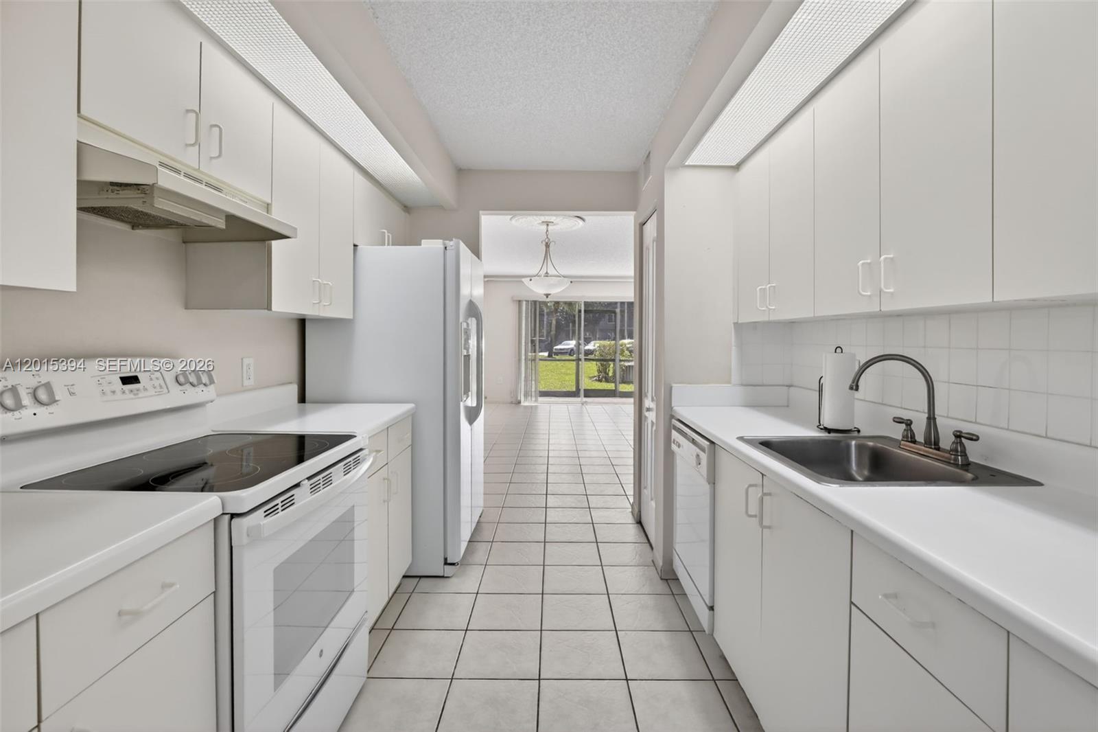 Located in one of the newer constructed buildings. This well-kept, two-bedroom, two-bathroom ground-floor condo boasts 1,137 sq. ft. of living space. The galley kitchen seamlessly connects to the dining room, featuring a cozy breakfast nook and galley-style kitchen. Equipped with stainless steel appliances, the kitchen offers both functionality and elegance. The tile and wood-based laminate flooring located in the bedrooms. Both bedrooms showcase custom walk-in closets, offering ample storage. Bathrooms maintained pristine condition. Equipped with a stackable washer and dryer inside. Manicured landscaping with a very private forest-like nature view provides a tranquil retreat from the patio. Ideally located within walking distance to the main entrance, pickleball courts, and Club Health gym. HOA fees includes cable, internet, and full access to all community amenities — including free transportation, live theater shows, movie screenings, card rooms, heated pools, tennis courts, pickleball courts, and fitness center.