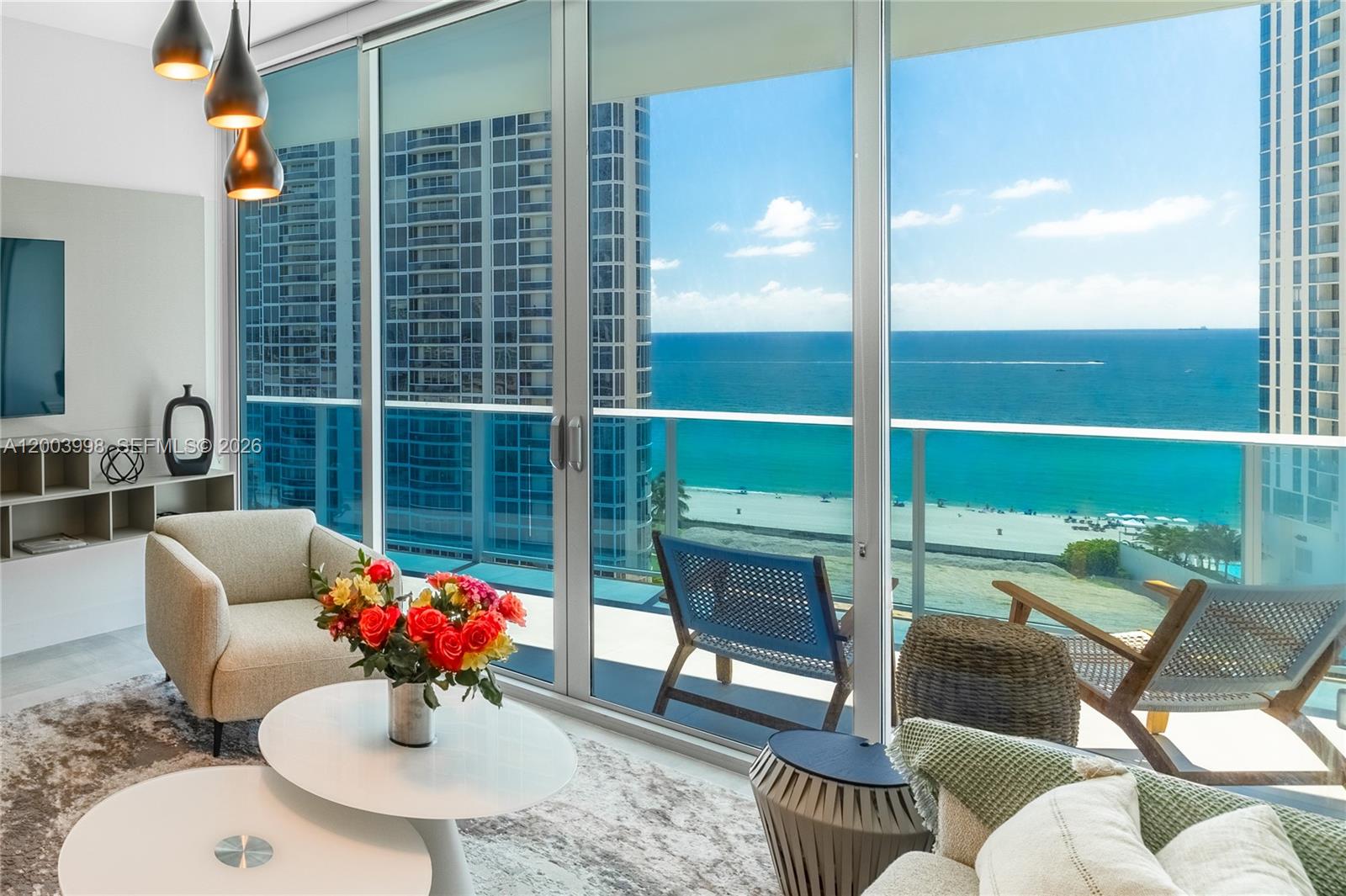 Stunning, spacious fully furnished ocean view residence located in Sunny Isles Beach renowned for its crystal-clear waters and pristine sandy beaches. This beautifully designer-furnished 2-bedroom + den, 2.5-bath condo offers refined coastal living with an open layout to enjoy breathtaking sunrises and sweeping 180-degree views of the Atlantic Ocean and Sunny Isles skyline from an oversized balcony accessible from every room. A private elevator foyer leads to an elegant interior featuring spacious built-in closets, SubZero and Wolf appliances, a fully equipped kitchen, and motorized shades with blackout options for full privacy.
A rare opportunity to own a  unit in one of the most sought-after lines in the building, featuring an additional enclosed den with custom-made sliding panel doors, thoughtfully designed and currently configured as both a guest (3rd) bedroom and a private office space.
Residents enjoy resort-style amenities including a gorgeous pool and sundeck area, fitness center, sauna, kids’ room, business center, and 24-hour front desk with security.
The building allows short-term rentals with a minimum lease term of 31 days, up to 12 times per year, offering exceptional flexibility and investment potential. Ideal also as a primary residence with access to A+ rated schools, nearby beaches, upscale shopping, and fine dining. Perfect as a second home, allowing owner to generate rental income when not in residence.