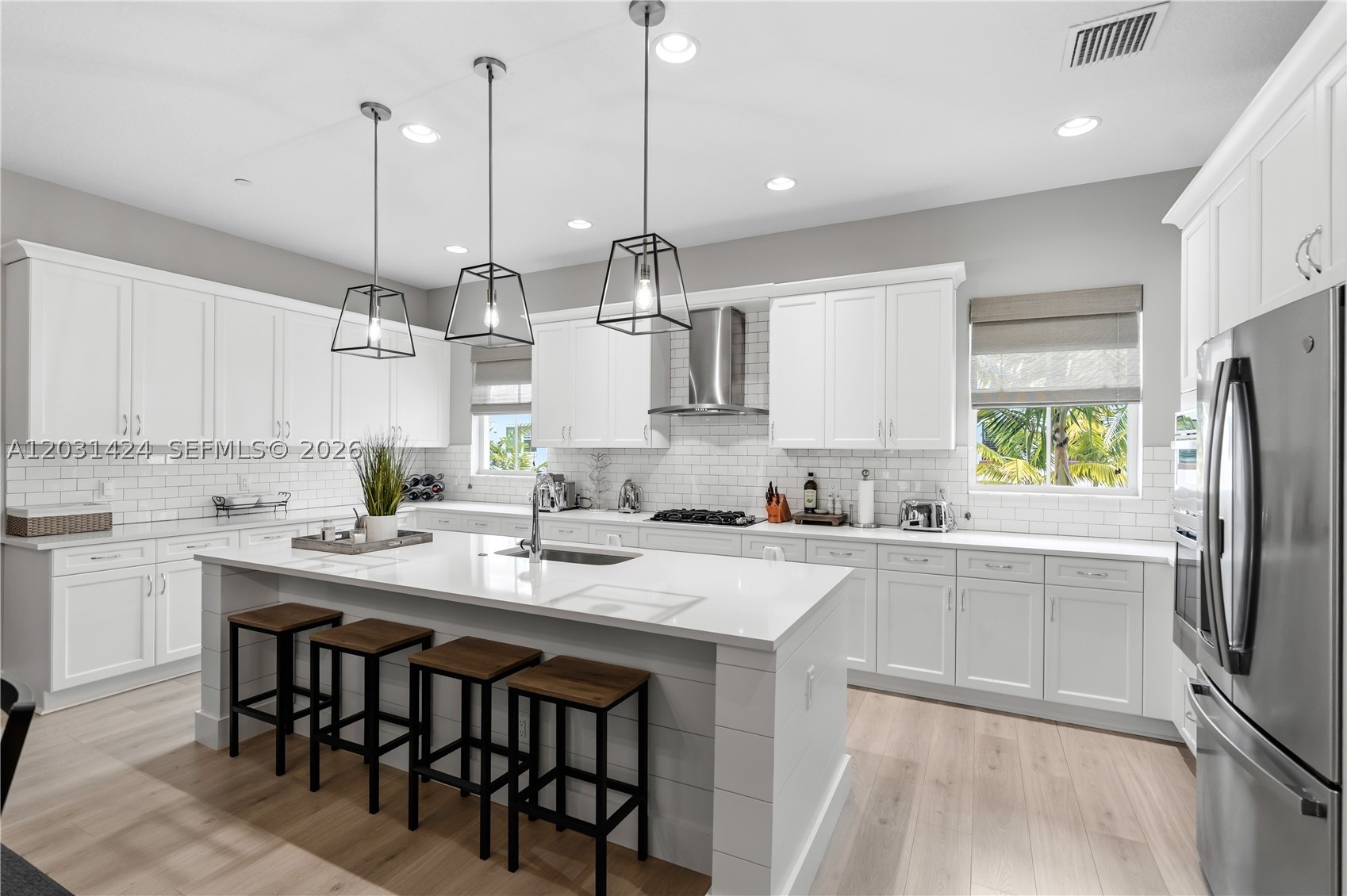 Experience luxury living in this absolutely stunning 3-bedroom, 3.5-bath townhome, perfectly situated in the prestigious Alton neighborhood at the heart of Palm Beach Gardens. From the moment you enter this light-filled, bright corner model, you'll be captivated by its thoughtful design and elegant features. The entry level features a versatile den or guest bedroom, a full bathroom, and a private patio that leads to a finished 2-car garage. Upstairs, enjoy an expansive open-concept kitchen with quartz countertops, high-end white wood cabinetry, state-of-the-art appliances, impact windows, modern light fixtures, and plantation shutters. The oversized island seamlessly connects to the formal dining and living areas, all of which are adorned with neutral vinyl flooring. Step out onto the large balcony for additional outdoor seating and relaxation. Retreat to the spacious primary suite, complete with a luxurious bathroom and custom walk-in closets. The ideal floorplan also includes two additional bedrooms and a full bathroom. Residents enjoy resort-style amenities including a pool, fitness center, tennis courts, pickleball courts, playgrounds, and more. This desirable location offers easy access to upscale shopping, fine dining, top-rated schools, beautiful beaches, and all major highways.