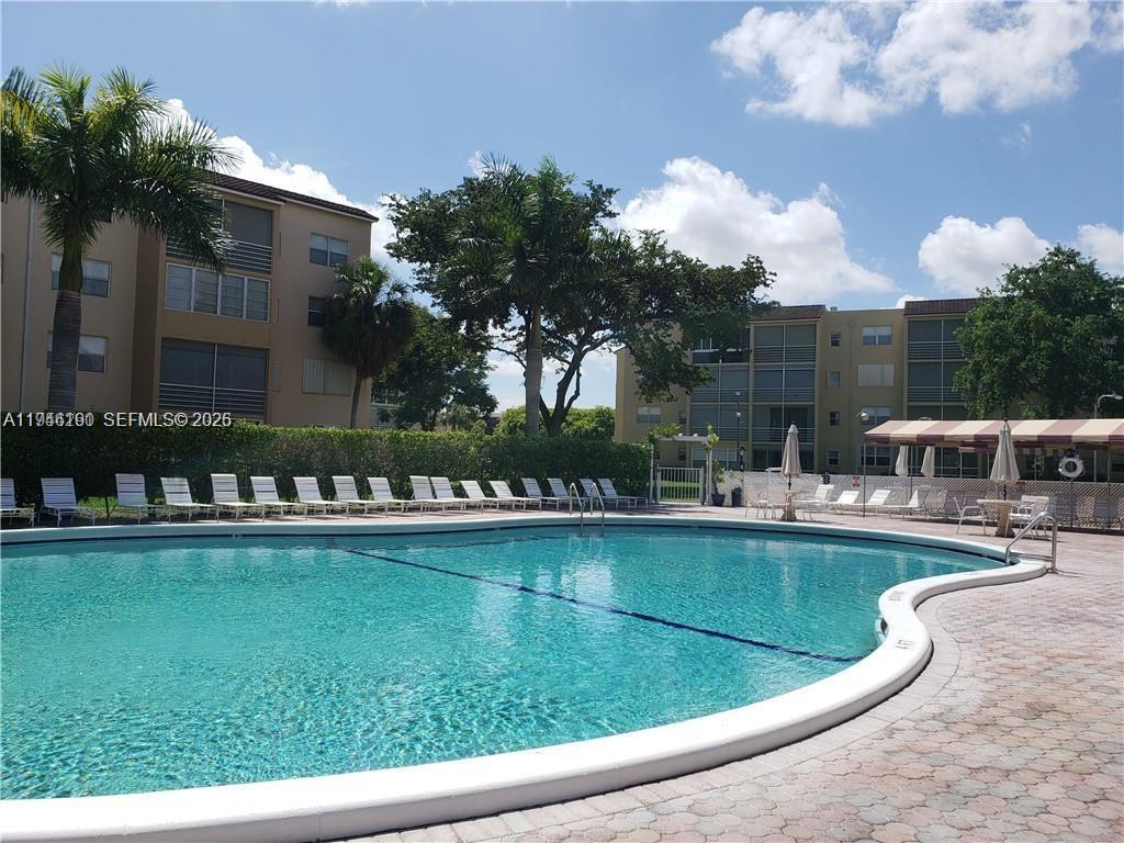 Just Reduced owner motivated! Discover this incredible opportunity in a prime location, surrounded by new luxury construction! This beautifully maintained residence boasts an all-tiled interior, neutral tones, and a bright Florida room. The spacious layout features ample closets and a convenient location. Enjoy easy access to I-95 and the Florida Turnpike, with the Fort Lauderdale Airport just 12 minutes away. The building has undergone a complete remodel, including a new roof, with no assessments due from the seller. Community amenities include a pool, tennis courts, clubhouse, exercise room, library, game room, and more. This active 55+ community offers well-kept grounds and a convenient lifestyle. Don't miss out – come and see for yourself!