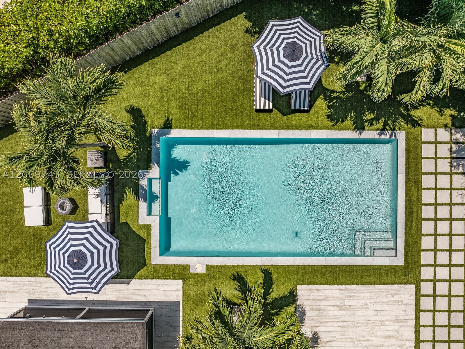 Tucked away behind a stately privacy hedge is Biscayne Park’s best kept secret— a just-renovated midcentury pool home retreat, dripping in high-end, luxe modern design. Welcome to Silver Palms! Enjoy fantastic resort-style living, complete with: open-flow living and dining; bright new eat-in quartzite waterfall kitchen with coffee station and high-end appliances; wide plank light oak wood floors; two double en-suite primary bedrooms; new modern designer baths; custom wood-slat paneling details; updated electrical, lighting, water heater, impact windows-doors; and premier tropical rear gardens with 30’x15' chilled-heated lap pool, Trex and porcelain decks, premium turf grass, and a beautiful screened-in porch. All with a spacious conversion-ready two-car garage and plenty of guest parking.