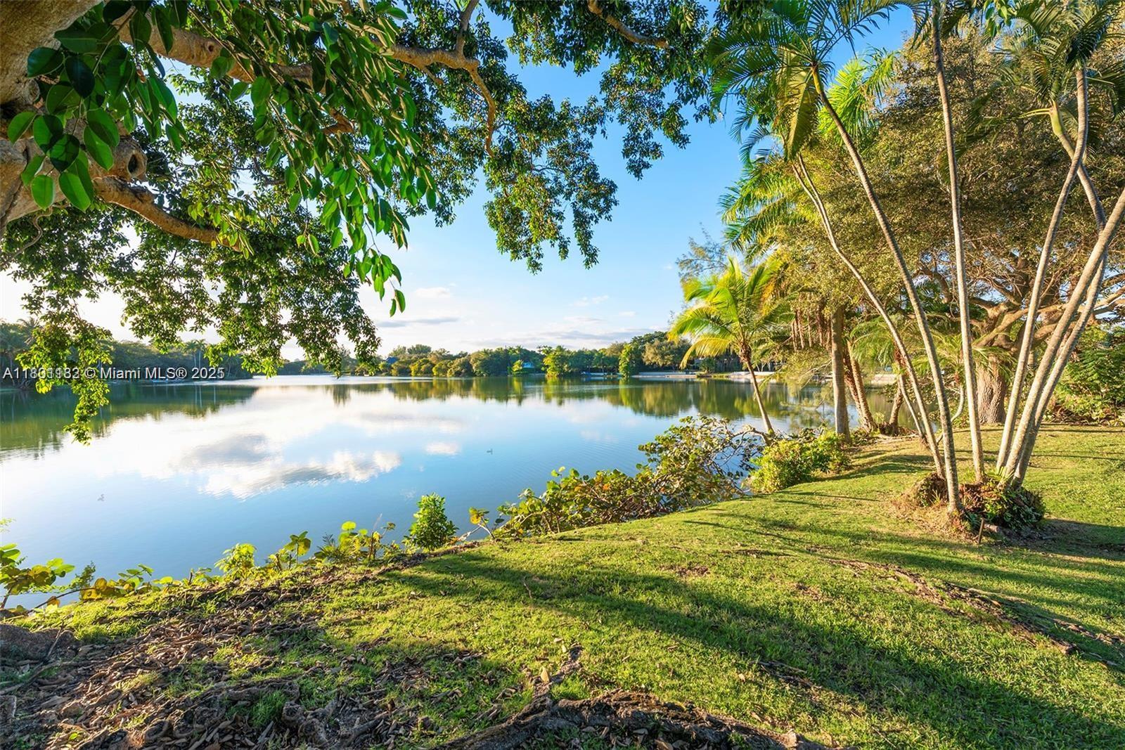 Best view lot in Hammock Lake on widest part of the lake and longest view. Seize the rare opportunity to craft your lakefront sanctuary in prestigious, gated Hammock Lake. Nestled on a lush acre, this prime lot and residence promise breathtaking sunset vistas. Expand and enhance the existing Mid Century single-story home, or build your own masterpiece from the ground up. Situated in one of Coral Gables’ most desirable neighborhoods, this property delivers unmatched potential to transform your dreams into reality. Experience the tranquility and remarkable appeal of this sought-after lakeside location.