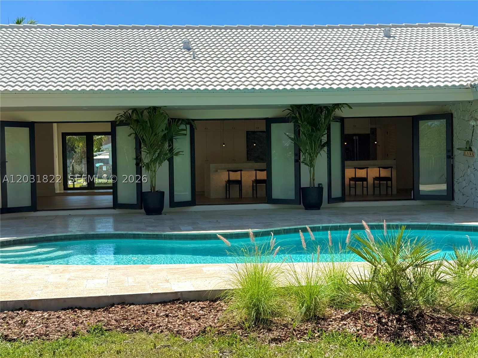 Meticulously renovated split plan Palmetto Bay home by husband and wife architectural design team. Reimagined for modern living with open kitchen featuring marble 16' marble kitchen island that seats up to 7. Home features include impact windows and doors, 3 car garage, engineered oak wood floors, shell stone tile, large open kitchen concept with new SS appliances and volume ceilings, all PVC plumbing, new ACs, and beautiful open redesigned pool area. Dining room could possibly be used as an office also. This home is a split plan layout with 3/2 on one side and a 1/1 on the other. New beautiful landscaping in both the front and back yard for your enjoyment under the covered patio. Main space of the home connects with the outdoors through a series of 3 double doors to bring the outside in.