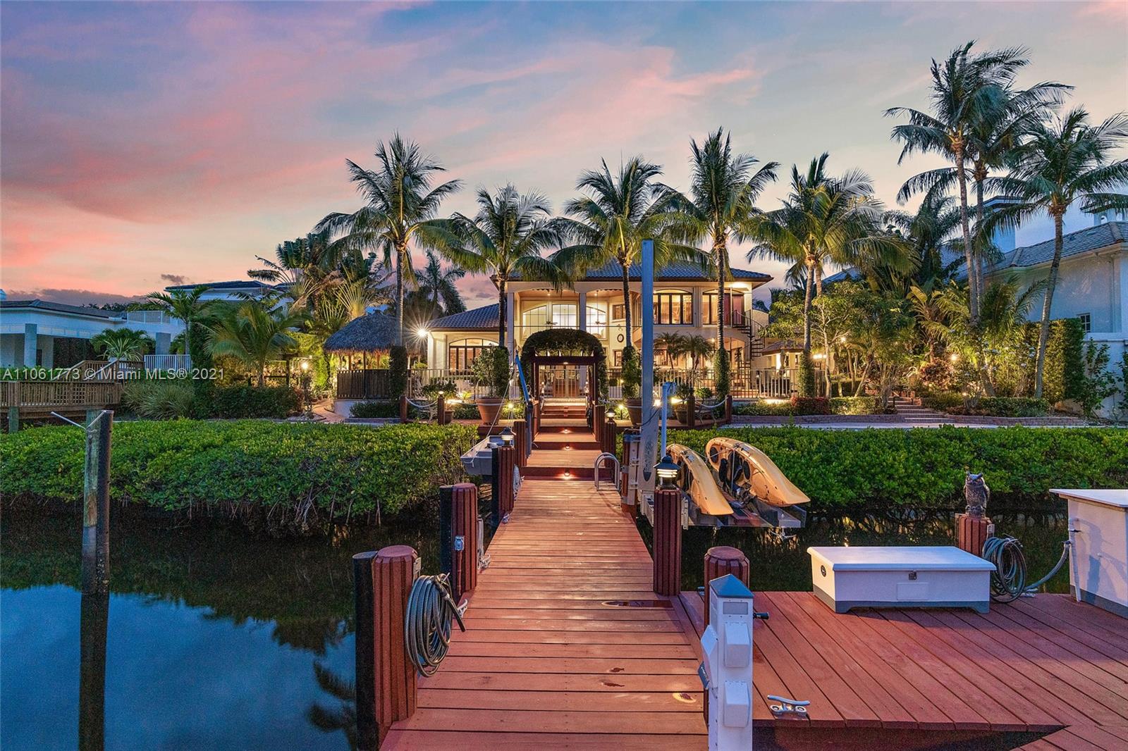 This Waterfront Estate is perfect for the Buyer that wants it all! Located on a private island street with waterfrontage that can accommodate a large vessel. Easy access to the Intracoastal and it is close to all the 5 star amenities that Admirals Cove has to offer. The custom built, Tuscan inspired home, is over 5,800 square feet with a perfect blend of formal and casual living. Lush landscaping, custom wood work, 5 bedrooms, one of which is a private guest apartment, screened in patio, dock for 2 boats with a 12,000 lb. lift and swing lift for jet skis or kayaks, 60 k generator, air conditioned 4 car plus golf cart garage and so much more! This home is classic sophistication and timeless elegance at its best.