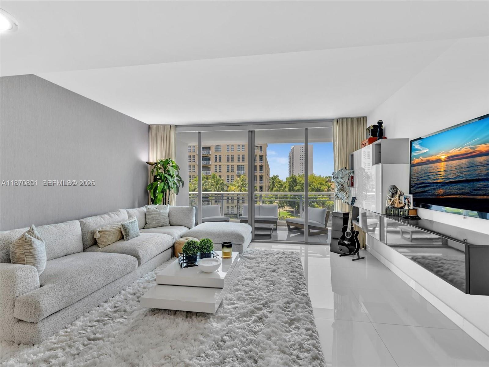 Modern waterfront living at Artech Residences in Aventura. This bright two-story loft-style condo offers 1,552 sq ft with soaring ceilings, floor-to-ceiling windows, and a flexible open layout rarely found in the Aventura condo market. The residence features 2 spacious bedrooms with ensuite baths and private balconies, plus an enclosed first-floor den ideal for a home office, gym, media room, or guest suite. The open kitchen showcases a waterfall-edge island, custom breakfast nook, and sleek modern cabinetry, seamlessly connecting to expansive living and dining areas designed for both everyday living and entertaining. The primary suite includes a contemporary bath with glass accents and clean designer finishes. Enjoy a true Miami waterfront lifestyle with resort-style amenities including two pools, spa, state-of-the-art fitness center with yoga studio, private cinema, racquetball court, EV charging stations, and direct marina and boardwalk access. Prime location just minutes from Aventura Mall, beaches, waterfront parks, top dining, golf courses, and the Aventura Community Recreation Center.