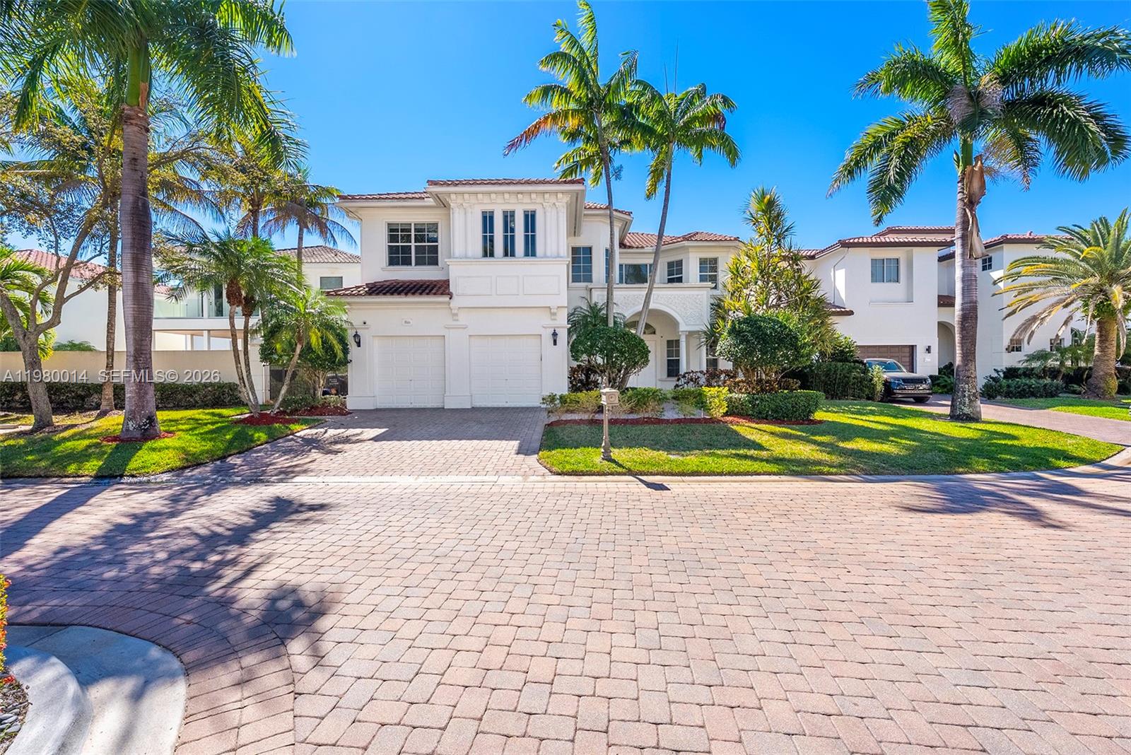 Contemporary two-story home located in the highly sought-after gated waterfront community of Harbor Islands in the Grand Harbor Estates section. This spacious 5BR/4.5BA residence features an expansive open floor plan with volume ceilings, marble floors, impact windows and doors, and abundant natural light throughout. Fully equipped kitchen with ample cabinetry and opens to both a formal dining room and breakfast area, ideal for everyday living and entertaining. The spacious primary suite features a separate sitting area (gym or office), walk-in closet and a spa-inspired bathroom designed for relaxation.  Enjoy South Florida living in the large private backyard featuring a covered terrace, summer kitchen, and pool, perfect for entertaining and outdoor gatherings while offering privacy. The home also features a two-car garage and a desirable street position within the community.  Harbor Islands offers resort-style amenities including clubhouse, fitness center, tennis courts, pickleball, pool, spa, parks, and a marina for boating enthusiasts. Ideally located just minutes from the beach, shopping, dining, and major roadways, this home offers the perfect blend of comfort, convenience, and lifestyle in one of the area’s most desirable communities.